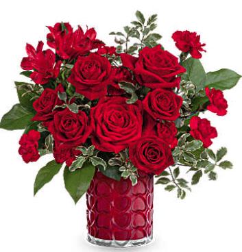 Radiant Hearts - As radiant as your love, this romantic Valentine's Day bouquet shines beautifully in a pearlescent vase adorned with an embossed heart pattern. This Valentine's Day bouquet showcases red roses, red spray roses, red alstroemeria, and miniature red carnations, complemented by lemon leaf and pitta negra. Teleflora's Radiant Hearts Bouquet is delivered in Teleflora's Enchanted Hearts Vase (while supplies last).