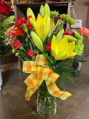 A Little Sunshine  - This cheerful arrangement is filled with bright colored flowers to bring a little sunshine to anyone's day! In this mixture you will find carnations, daisies, and mums. 