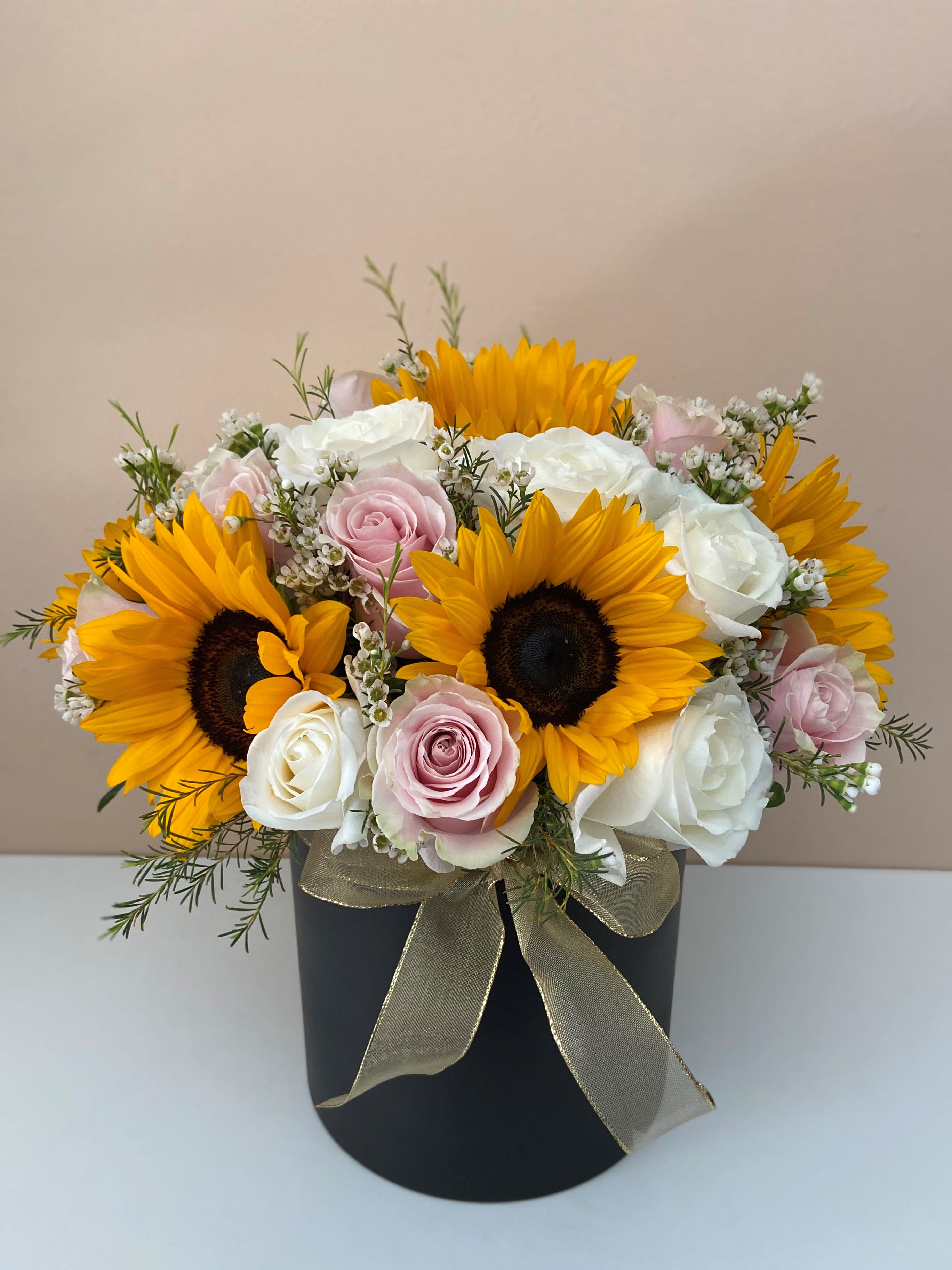 Corina Box - Black Cylinder with 5 Sunflowers and 12 White Roses and 12 Pink Roses. 