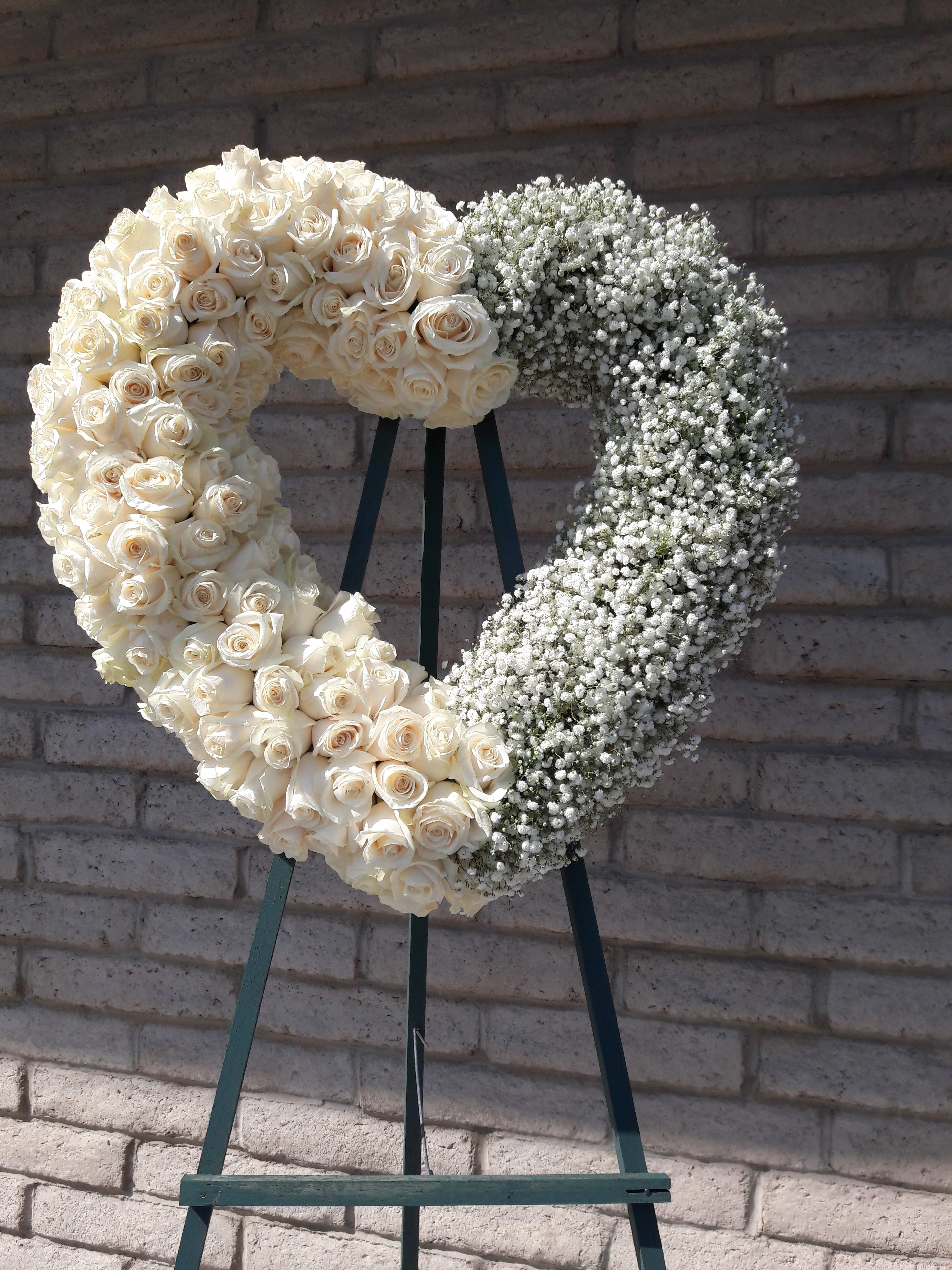  Jazmin's Loving Embrace  - A tender and classic tribute to a precious life. Heartfelt emotions and sympathies find delicate expression here. Roses and babies breath make this a one of kind heart.  Specify in special instructions what color roses. 