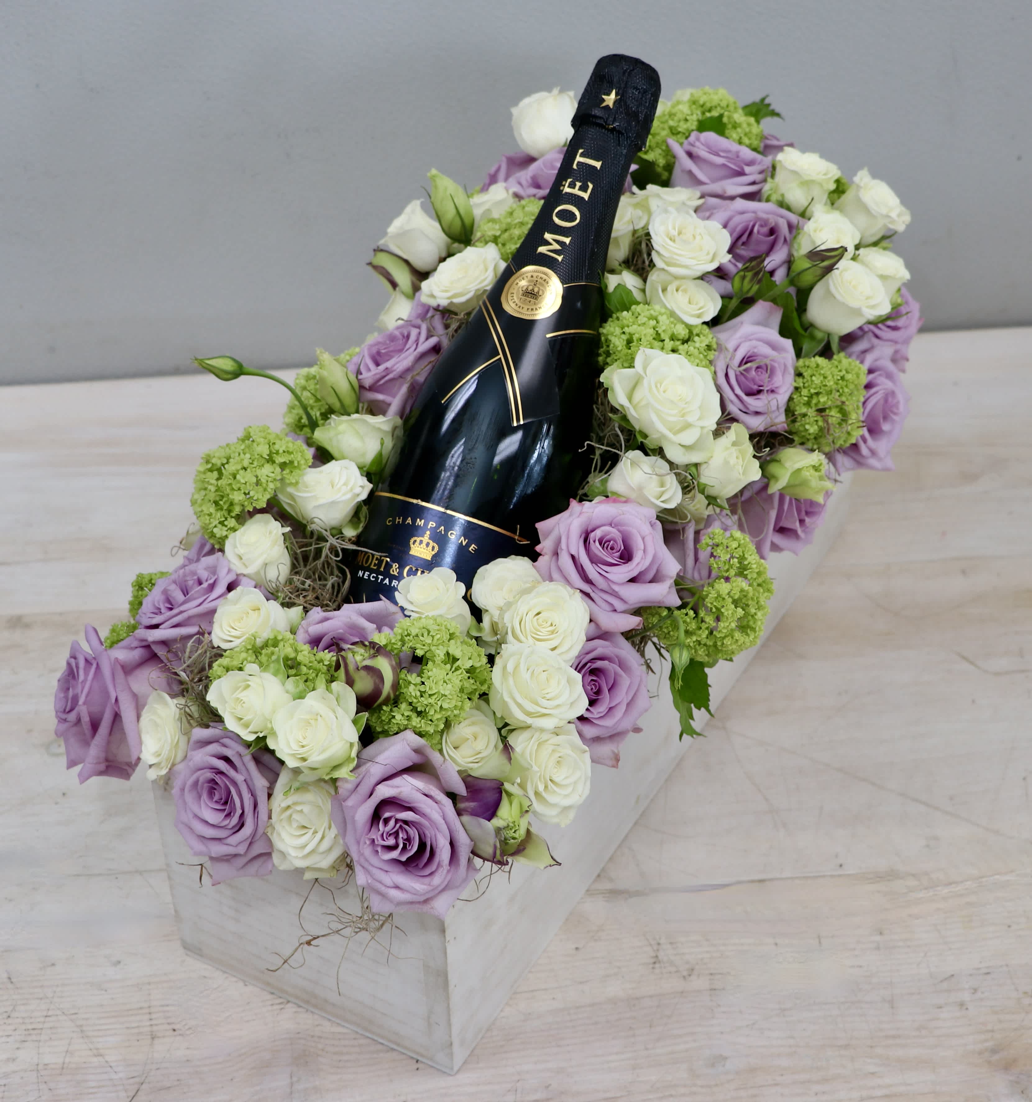 Dreamy Lavender Gift - WeHo - Your favorite bottle of bubbly nestled in a bed of lavender and white roses.   Please call or text about bottle selection 