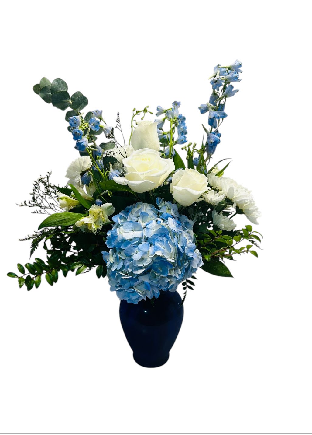 Thoughtfully Yours - This stunning floral arrangement features a sophisticated blend of blue and white blooms, evoking a sense of tranquility and timeless elegance. Designed in a deep navy vase, the contrast between the soft flowers and the dark base enhances its refined aesthetic. Perfect for everyday, holiday and sympathy.  All around design, 24&quot;h x 17&quot;w