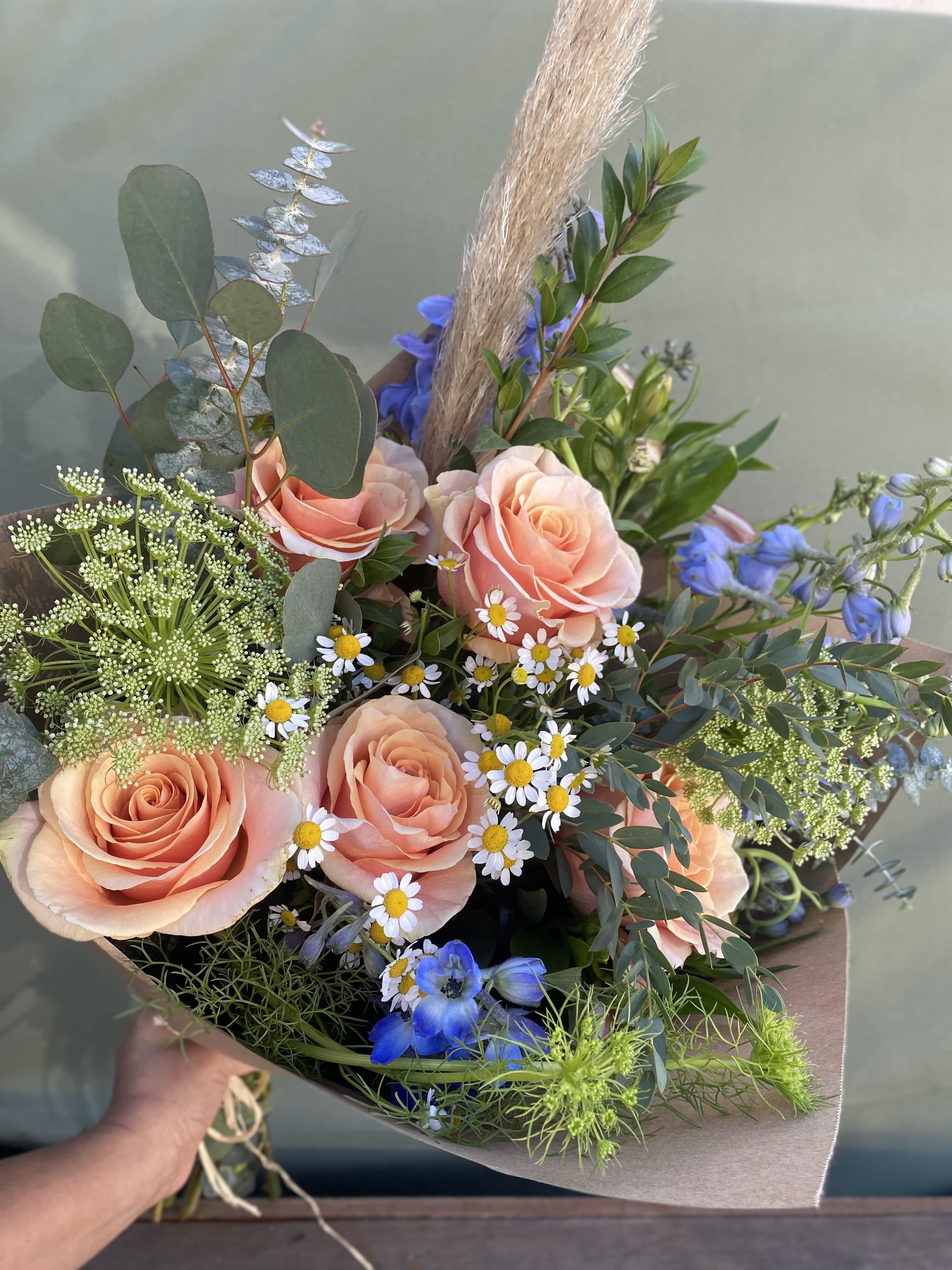 Dreamy Meadows  - A hand wrapped bouquet with roses, eucalyptus, delphinium, and Queen Anne lace. 