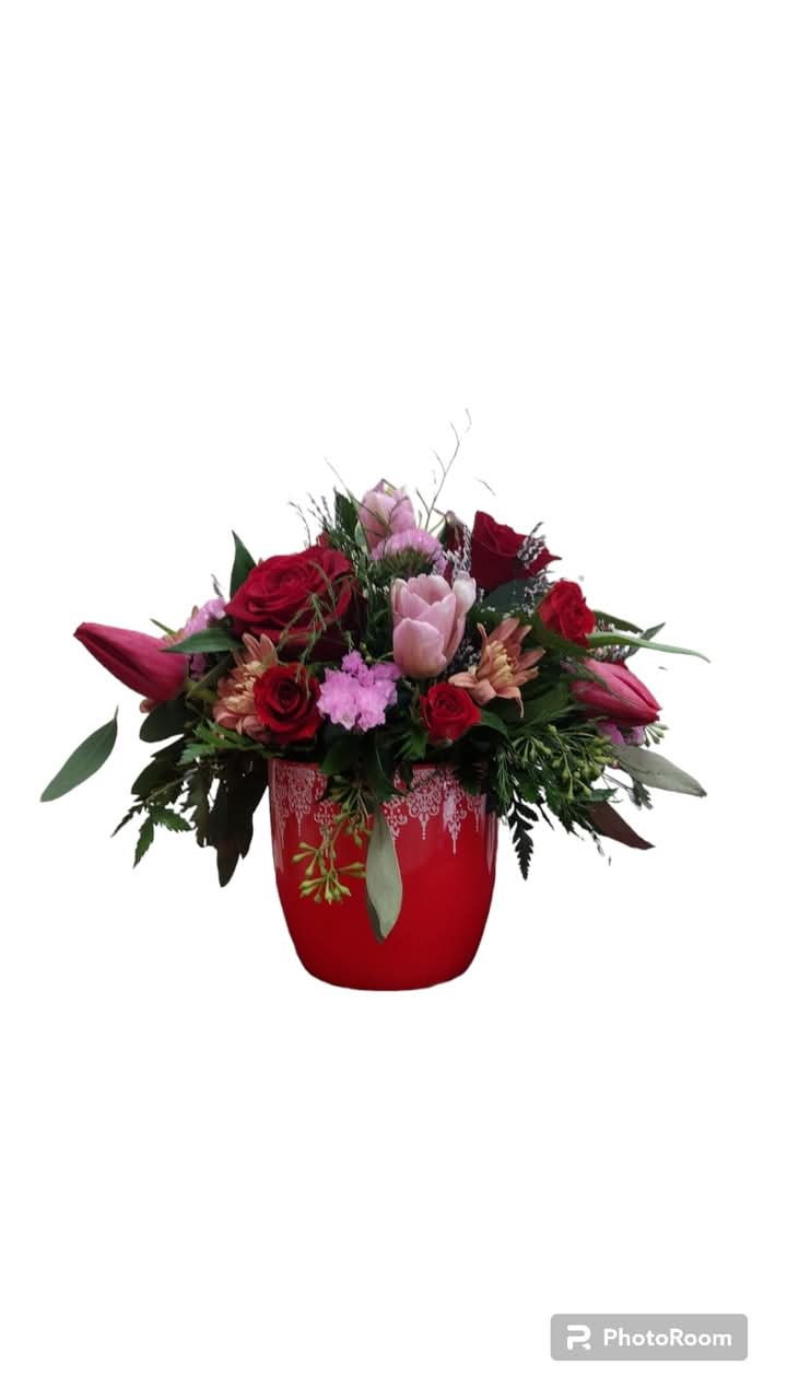 Crimson Bloom Delight  - Crimson Bloom Delight is an exquisite arrangement featuring a striking red container filled with a lively mix of pink and red flowers, including roses, tulips, daisies, and poms. This vibrant floral display is designed to enhance any environment, making it an ideal gift or a beautiful addition to your home decor.