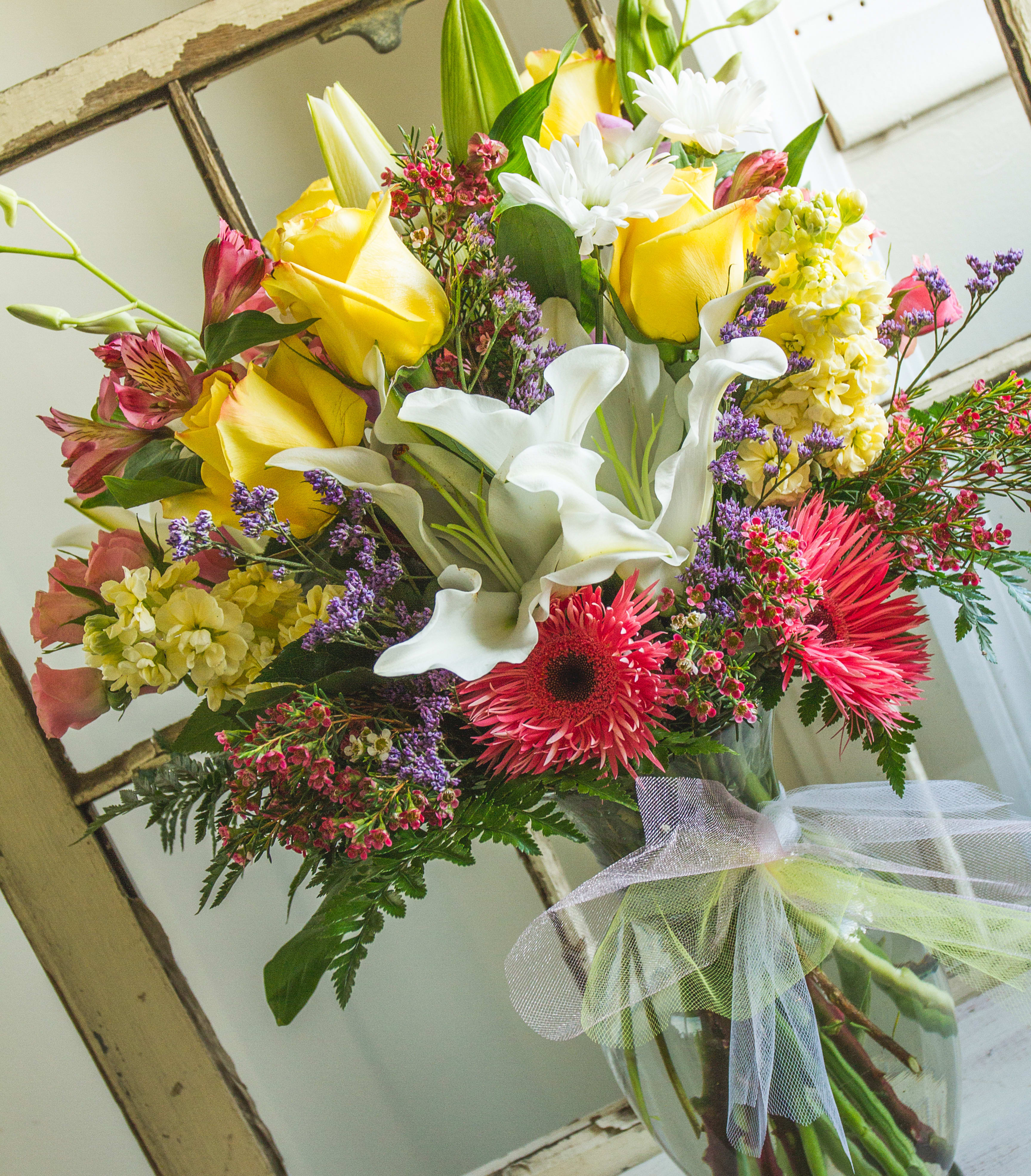 Julie's Garden -  Roses, Stock, Spray Roses, Lilies, Daises, and filler in a vase with tulle. 