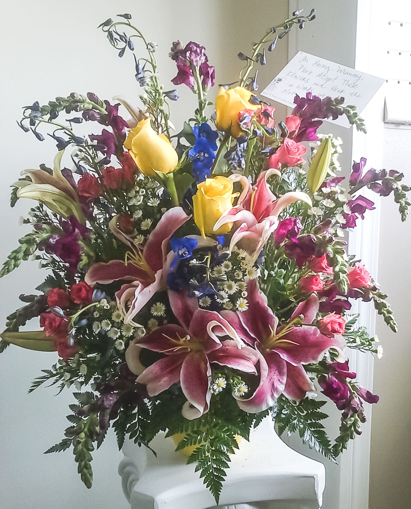 Evelyn Evelyn - Roses, Spray Roses, Lilies, Delphinium, Stock, and various filler in a vase.