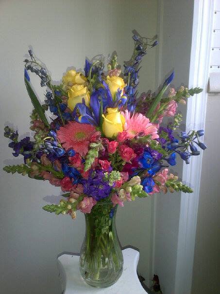 Mixed Melody - A brilliant mix of Roses, Gerbera Daisies, Delphinium, Snapdragons, Spray Roses, Iris, (Flowers may vary with season) in a vase. 