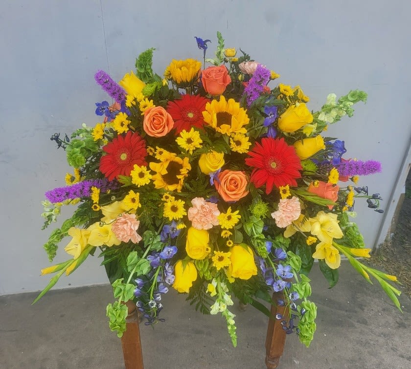 &quot;Sunlit Memories Casket Spray&quot; By Katherine's Flowers - Sunlit Memories Casket is a vibrant display combines bright shades with stunning textures while sharing thoughtful sentiments and comfort to loved ones.