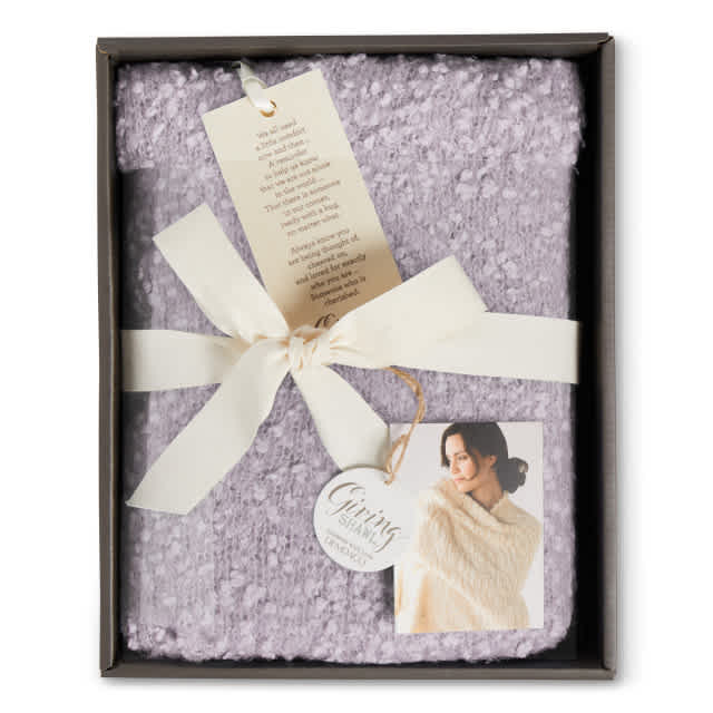 Giving Shawl Lavender or Pale blue - Our sophisticated, cozy collection of Giving Shawls is celebrating its fifth anniversary! Gift to a friend or loved one to let them know you're thinking about them and you care. Each shawl is crafted from sumptuously soft fabric designed for soothing comfort and presented in a beautiful gift box. Two deep pockets let you keep your must-haves close by for comfy ease. This incredibly comfortable taupe Giving Shawl includes a message of encouragement printed on a keepsake bookmark.