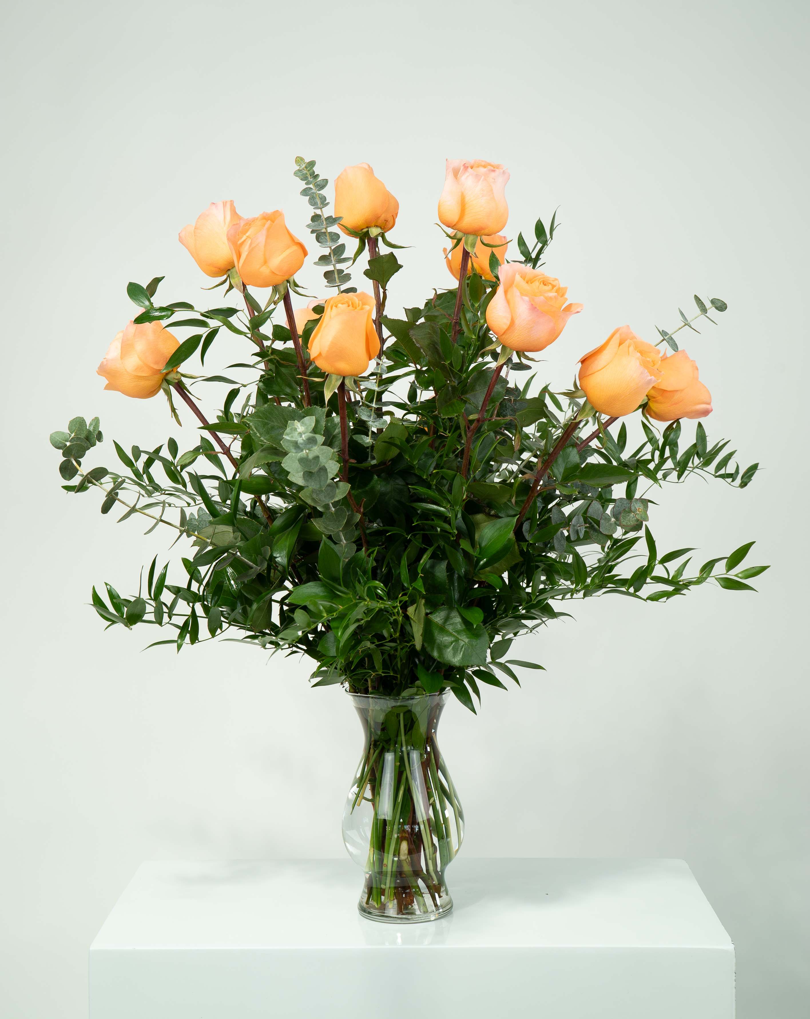 12 Peach Roses 12 Peach Roses - Like a peach these roses are juicy and fresh. Decorated with Italian ruscus, eucalyptus and the main ingredient, long stem peach roses. This will give off a light fragrance that will leave you wanting more.