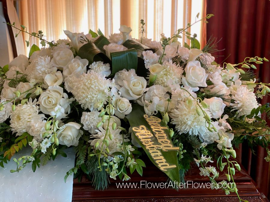 Tranquility Tranquility - An all white tribute, this full casket spray is pure and tranquil. Featuring a variety of white flowers and greenery, this elegant spray evokes a feeling of peace.