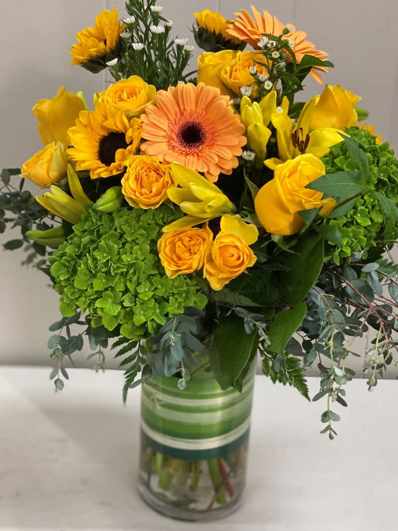 LOVE AND SUNSHINE!! LOVE AND SUNSHINE!! - This beautiful vase full of blooms in bold sunny colors will make their heart sing brightly. Each vase is artfully designed by our master florist and hand delivered to make their day shine!!