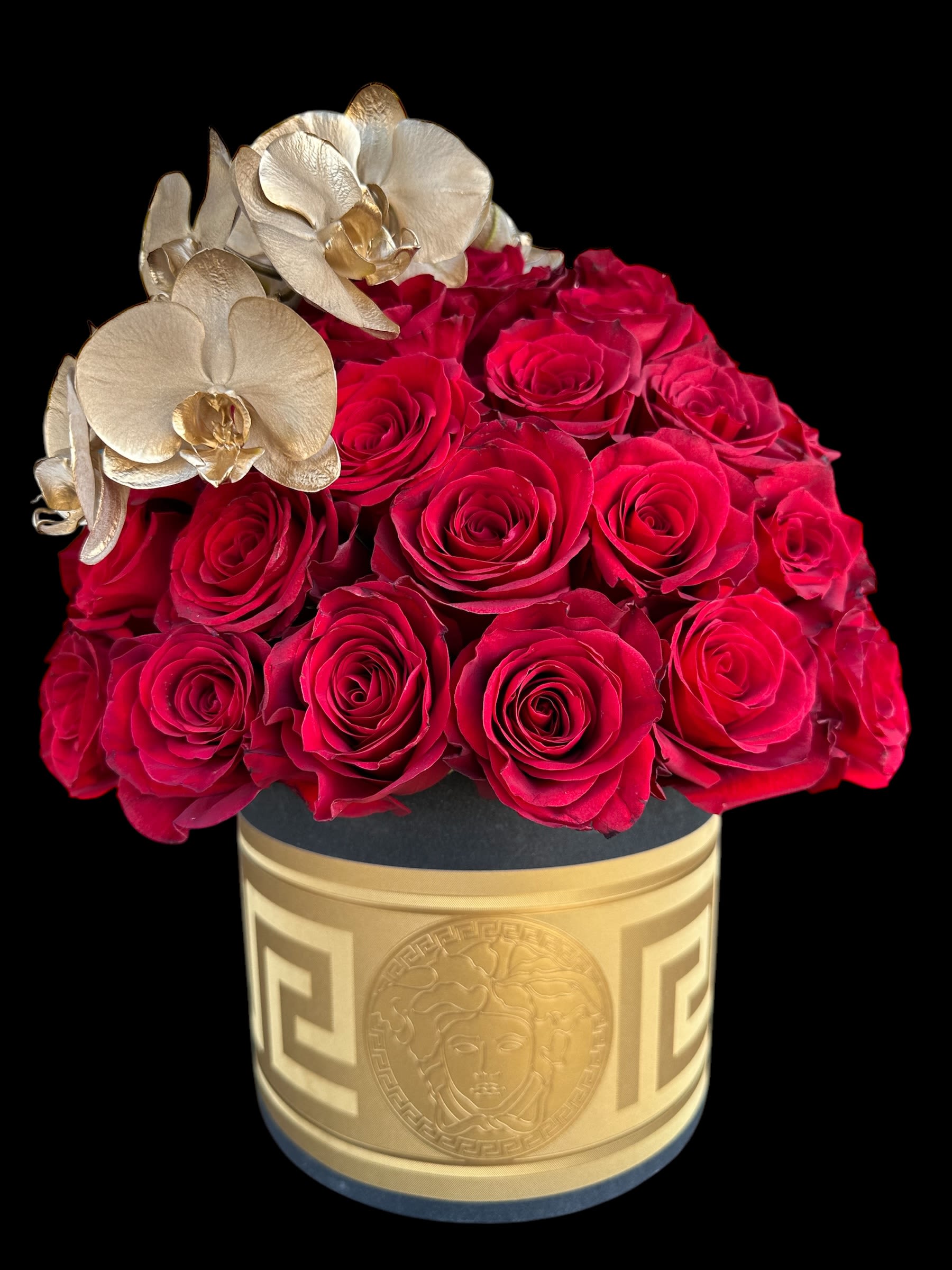 Chaney‘s VERSACE Luxury Box 1002 Chaney‘s VERSACE Luxury Box 1002 - Our award-winning floral designers created this handcrafted unique VERSACE  design of floral art. 50 super premium red roses decorated with a bow of fresh cut 24k GOLD orchids.