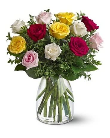 A Dozen Mixed Roses A Dozen Mixed Roses - From elegant white to cheerful yellow, sweet pink to dramatic red, this lush bouquet captures the rose in all its beauty - and will surely capture the heart of the lucky one to receive it. Three yellow, three red, three white and three light pink roses, accented with variegated pittosporum, arrive in a tapered glass vase. Approximately 14" W x 16" H Orientation: All-Around As Shown : TFWEB334