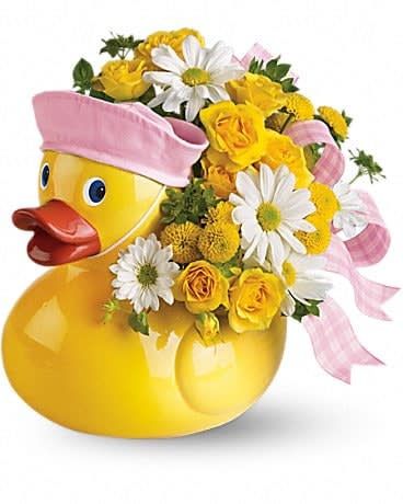 Ducky Delight - Girl Ducky Delight - Girl - This adorable arrangement takes to baby showers and baby arrivals like a duck takes to water! Available in boy and girl versions, this charming arrangement in its cute and reusable keepsake container is, well⦠just ducky! Sunny yellow spray roses, yellow button spray chrysanthemums and white daisy spray chrysanthemums are perfectly arranged with a light pink ribbon in an exclusive Just Ducky container. Hand- not stork-delivered! It's delightful.