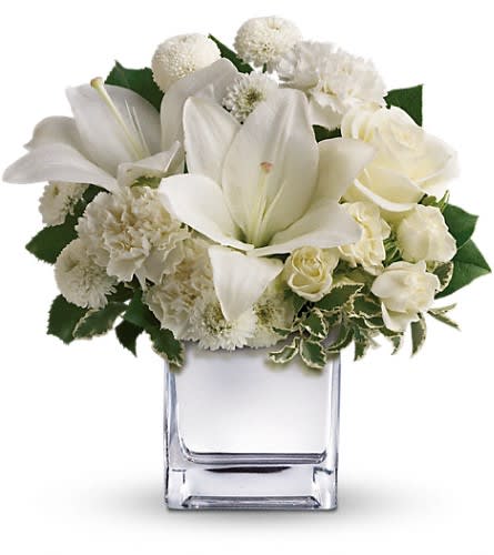 Peace, Love & Joy Bouquet Peace, Love & Joy Bouquet - The elegant bouquet includes white roses white Asiatic lilies white carnations and white button spray chrysanthemums and other white flowers accented with assorted greenery. Approximately 11" W x 11 1/2" H Orientation