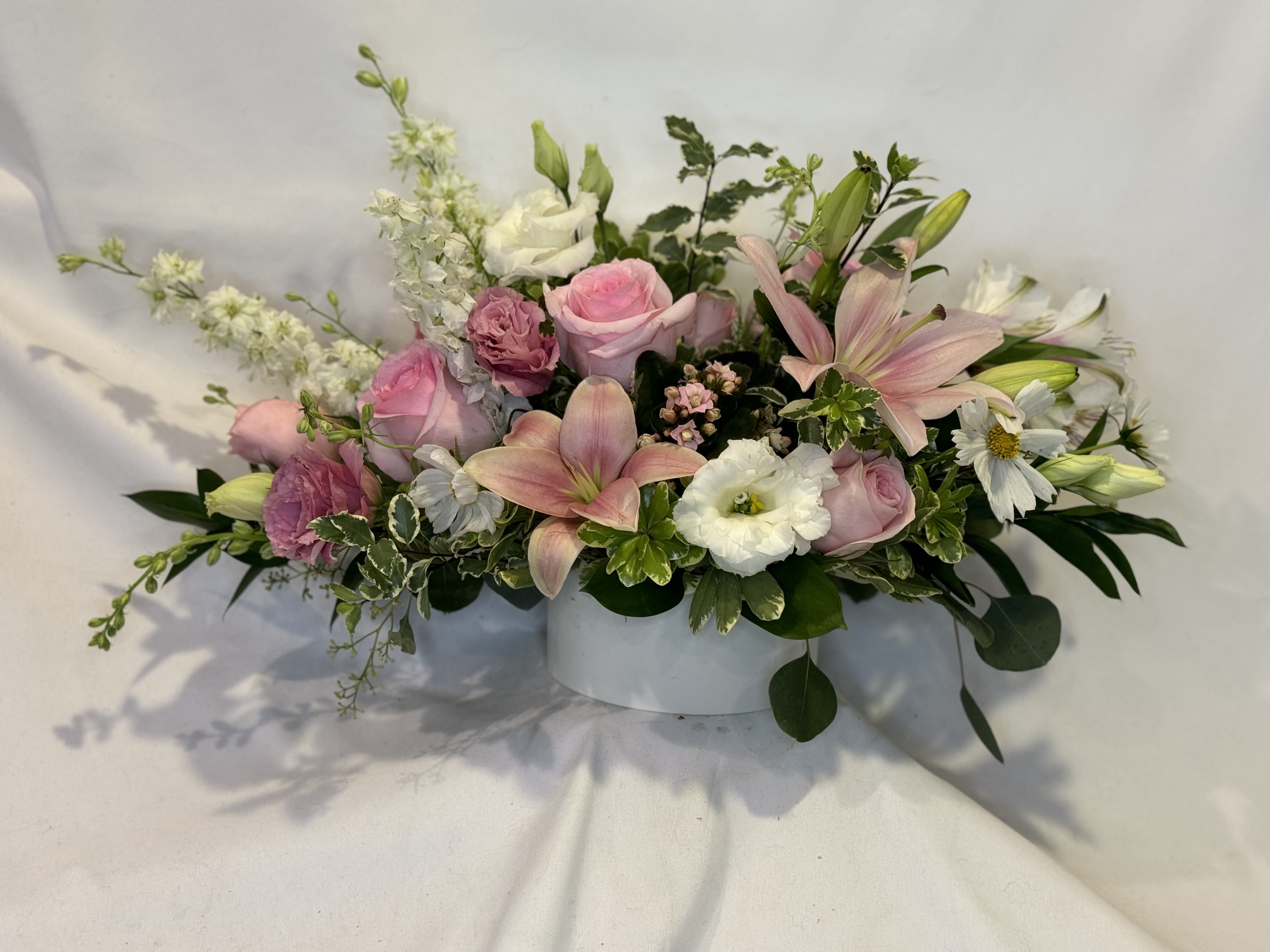 Simply Southern Centerpiece Simply Southern Centerpiece - This centerpiece is as southern and feminine as it gets! The light pinks and white blooms perfectly complement each other in this round white ceramic. A wonderful compliment for any table at any occasion!