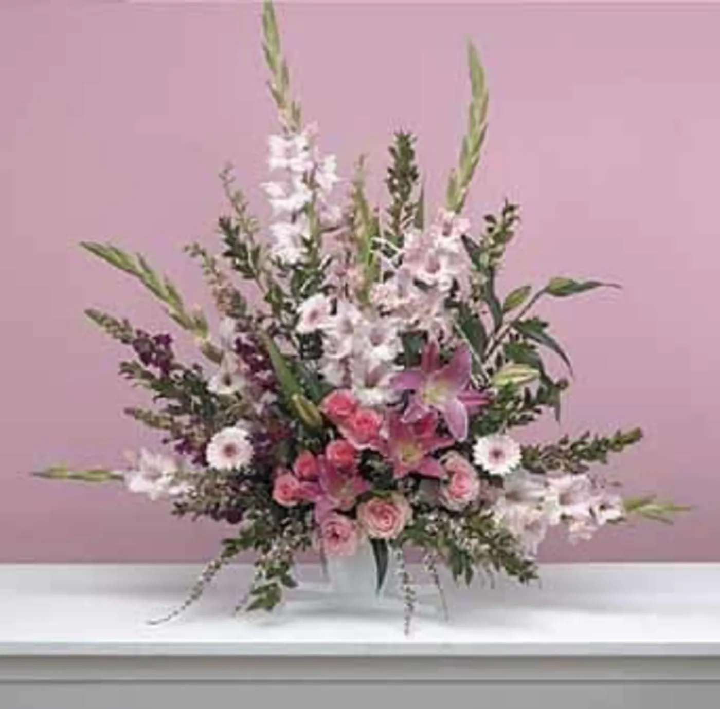 Delicate Tribute Delicate Tribute - Delicate mix of pastel flowers. The perfect tribute arrangement.