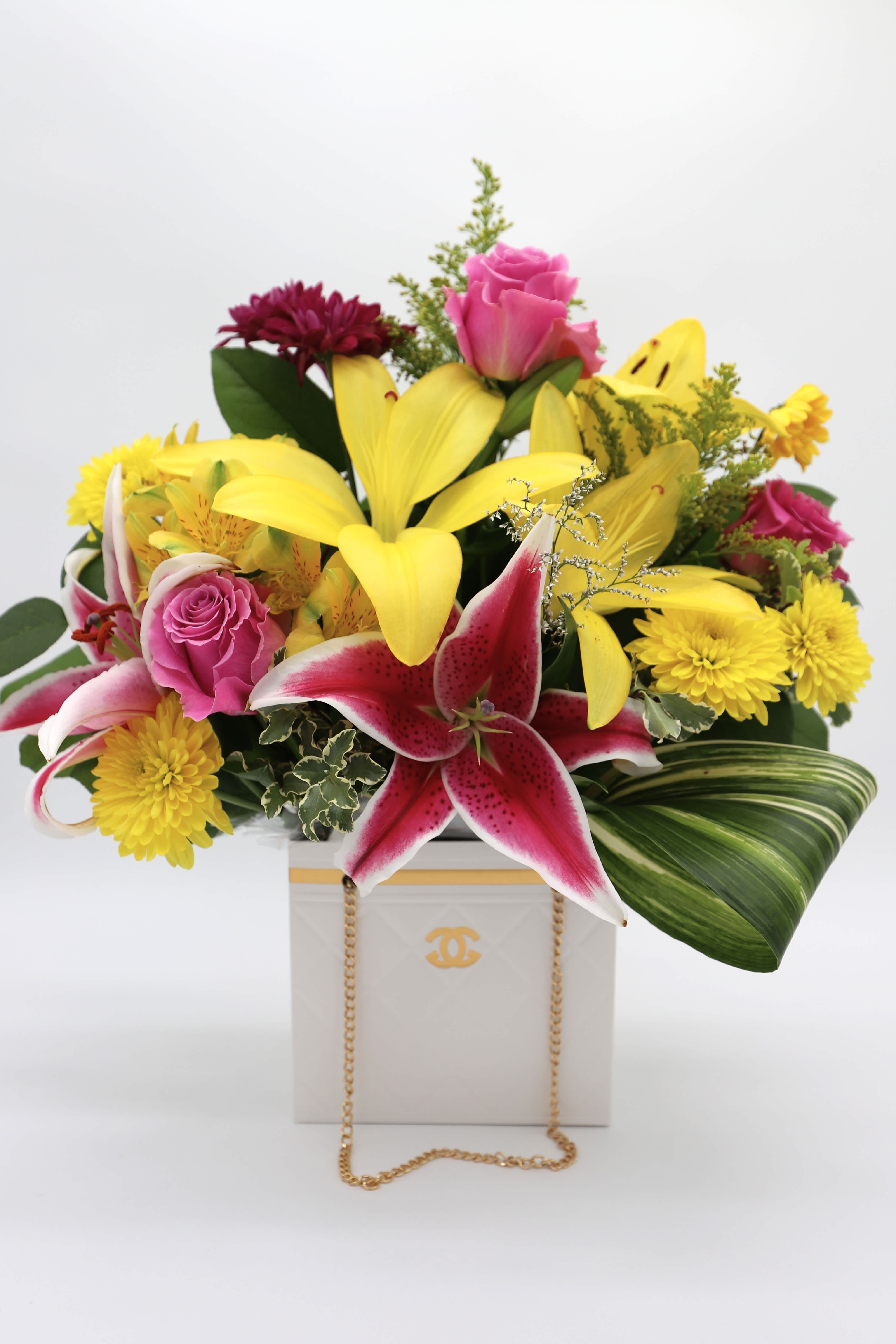 Adore You - A beautiful arrangement made with roses, mums, lilies and greenery made in a white paper &quot;designer&quot; bag.