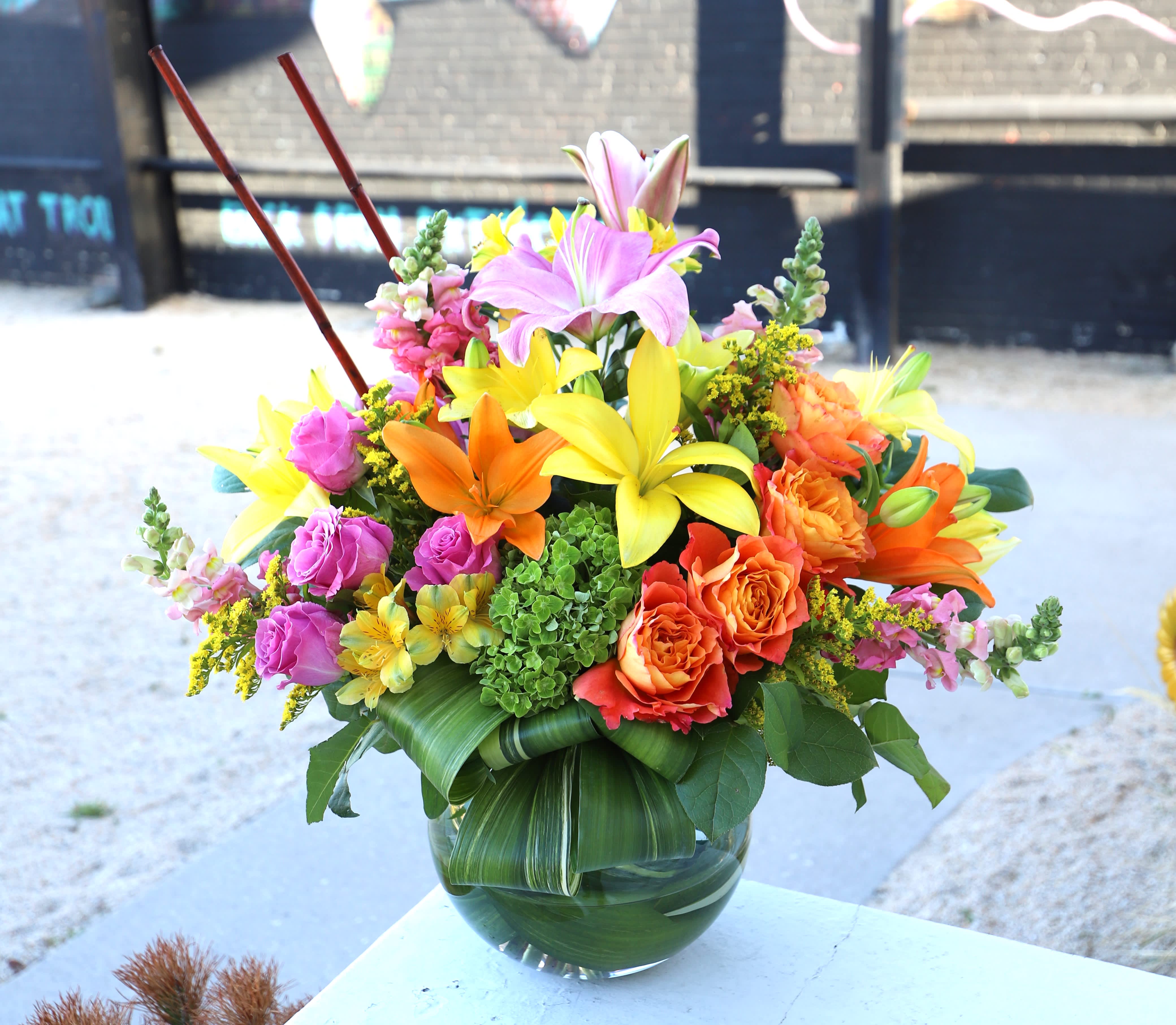 Sweet Sunset - A breathtaking arrangement made in a glass sphere vase with a mix of beautiful, fresh flowers.