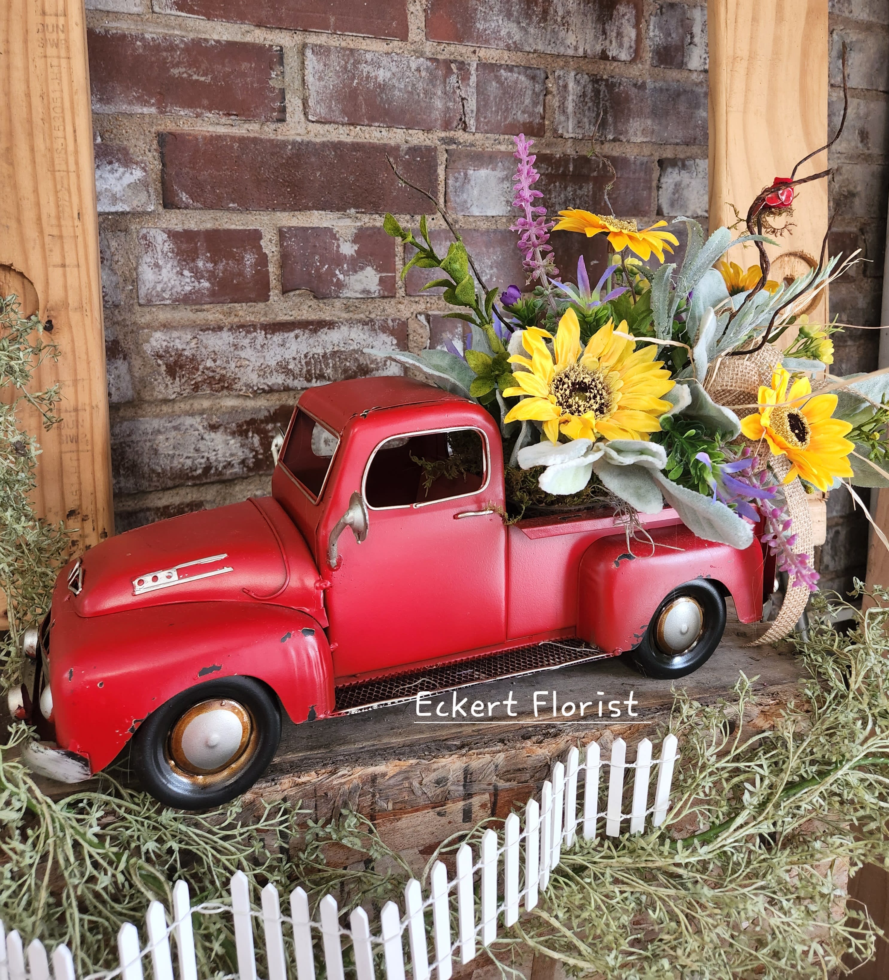Eckert Florist's Artificial Red Tin Truck Eckert Florist's Artificial Red Tin Truck - Made with artificial greens and flowers for Spring/Summer (Shown), this red tin truck measures 16" long x 6" wide x 6.5" tall. *Select Premium Upgrade and we will add 2 more pop-in interchangeable artificial arrangements for this truck 1 Autumn - 1 Winter *OUR LOCAL DELIVERY ONLY