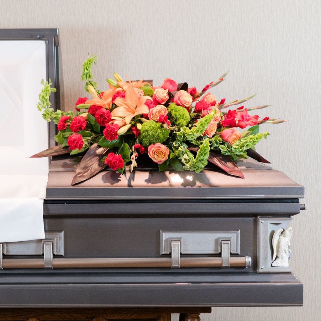 Farewell - Red and orange flowers in a traditional casket spray graciously honor one who has lived well.  Approximate Dimensions: 20&quot;T X 35&quot; W