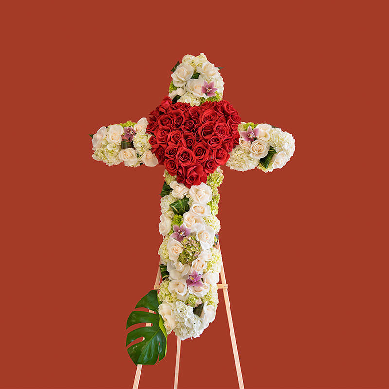 Loving Memory - This easel featuring a cross composed of roses displays love in mourning.