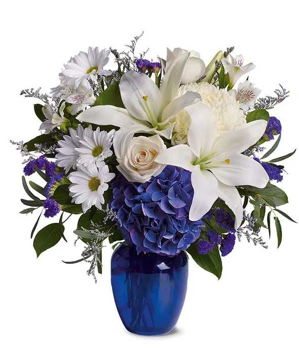 Beautiful in Blue Bouquet - Send a peaceful floral arrangement that is beautiful as a blue sky. Arranged with white lilies, white roses and blue hydrangeas. A perfect white and blue flower bouquet that is an ideal gift for a variety of occasions.  Please note: Hydrangea may be substituted if out of season.