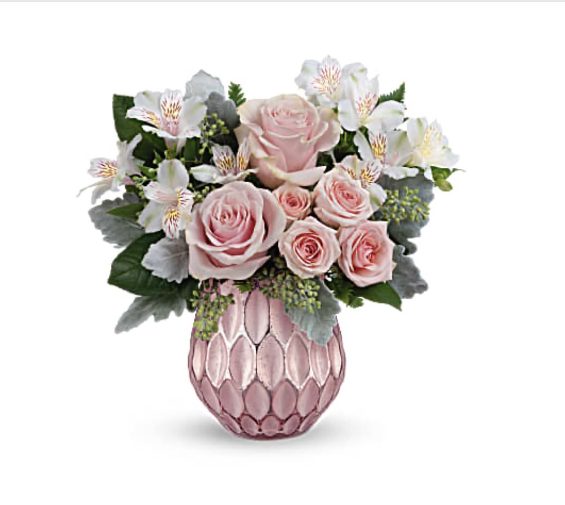 Soft Romance - A soft and romantic arrangement of pink roses, white alstroemeria, and assorted greenery, elegantly arranged in a shimmering pink vase. This bouquet is perfect for expressing love, gratitude, or simply brightening someone's day.