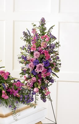 Blessings of the Earth Easel Blessings of the Earth Easel - Jewel-toned hot pink and lavender roses, fuchsia Mokara orchids, purple lisianthus, veronica and statice are accented with baby blue eucalyptus in this beautiful spray. Approximately 40H" X 18W"