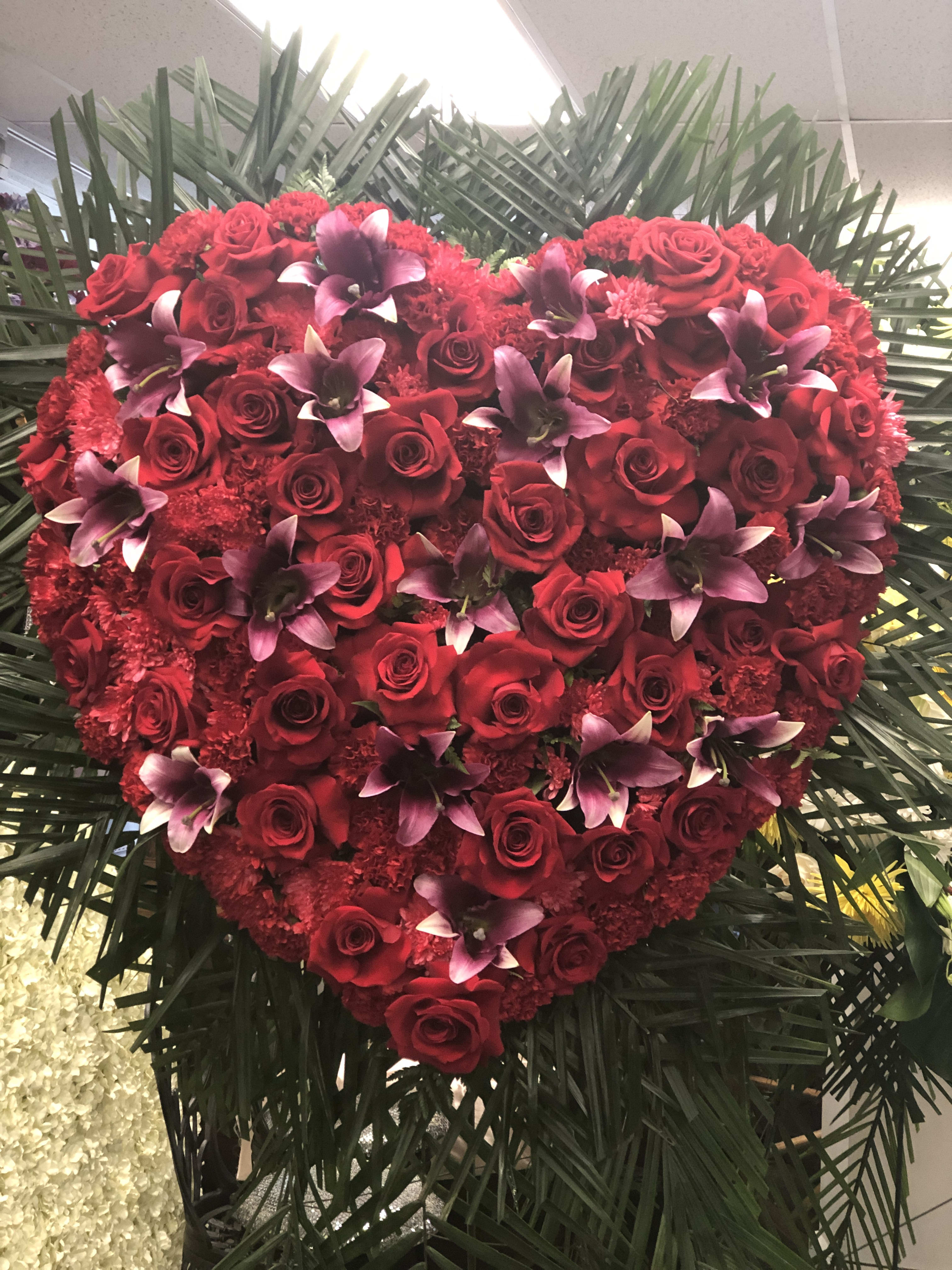 Sympathy heart with roses & lilies Sympathy heart with roses & lilies - A full heart of red roses and lilies, size of the hearty isa 24"
