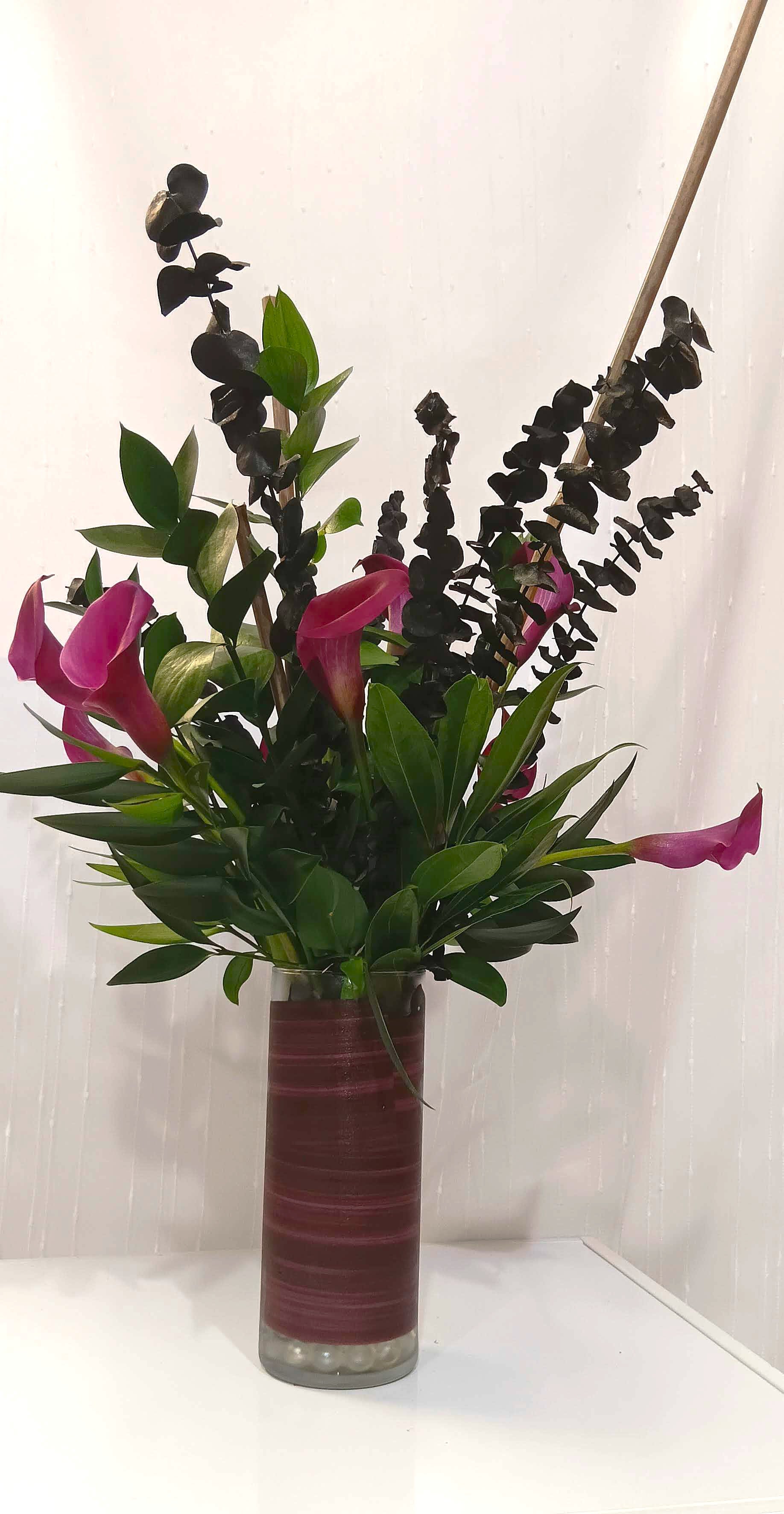 Dark and Moody Love Dark and Moody Love - Celebrating dark and moody love, this arrangement features dark calla lilies nestled with bamboo, eucalyptus, nagi and ruscus greens.