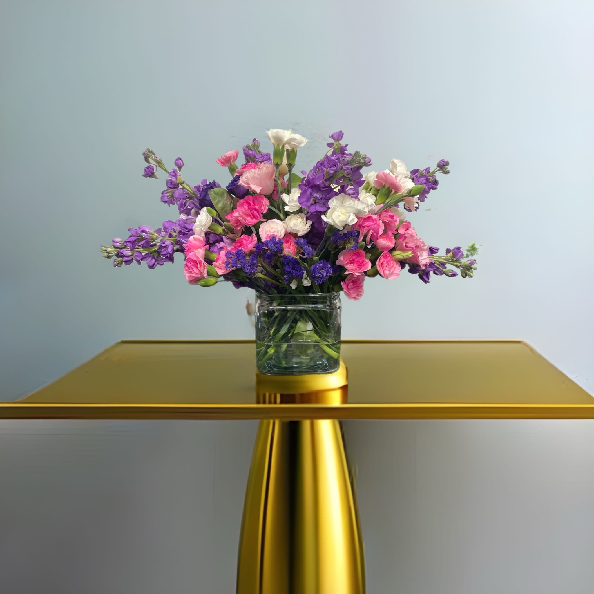 Twist and Shout by BloomNation™ - Flowers are fun! Especially when they look like this! Featuring sweet-smelling stock, spray roses, and carnations, this arrangement is a great surprise for Best Friends Day, Sister Day, or just because.  Approximate Dimensions: 10&quot;D x 10&quot;H