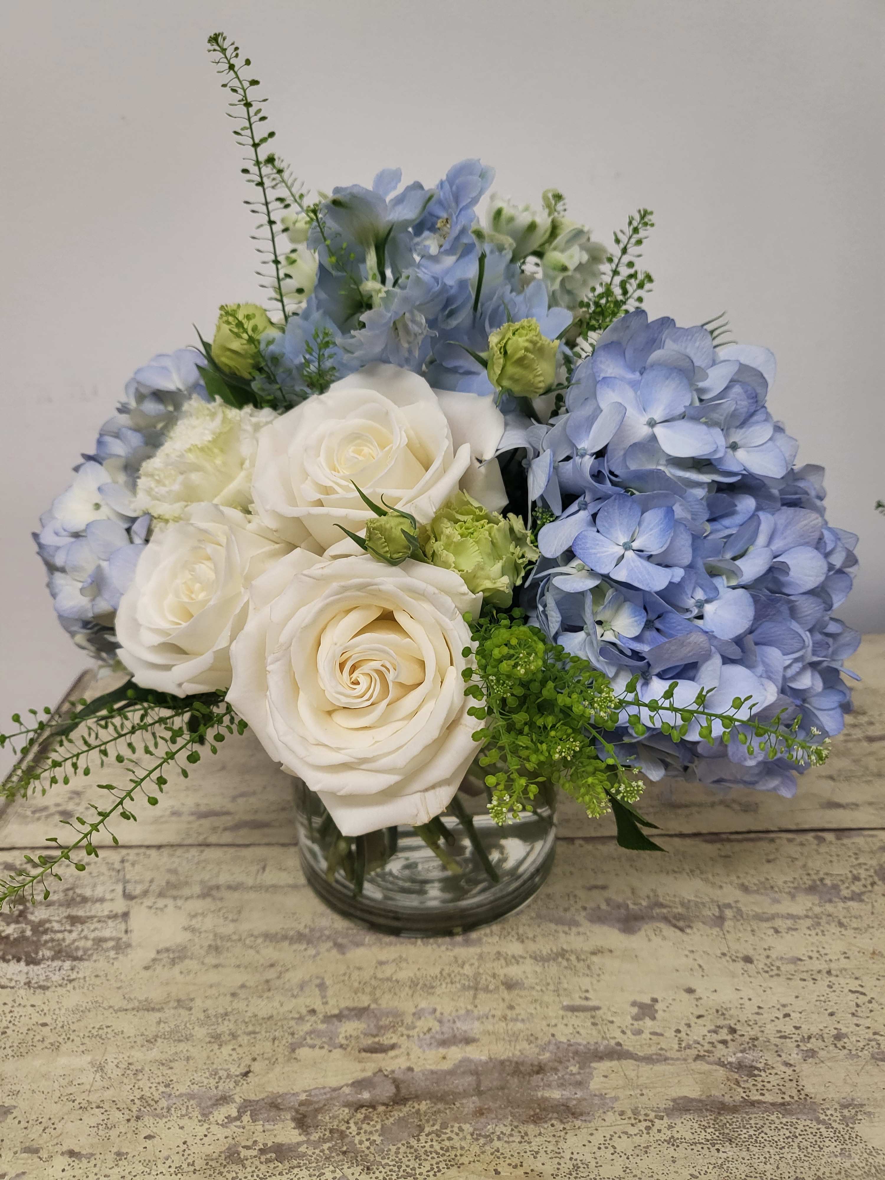 Blue Whispers  Blue Whispers  - A spring vase arrangement of soft blue and white blossoms,