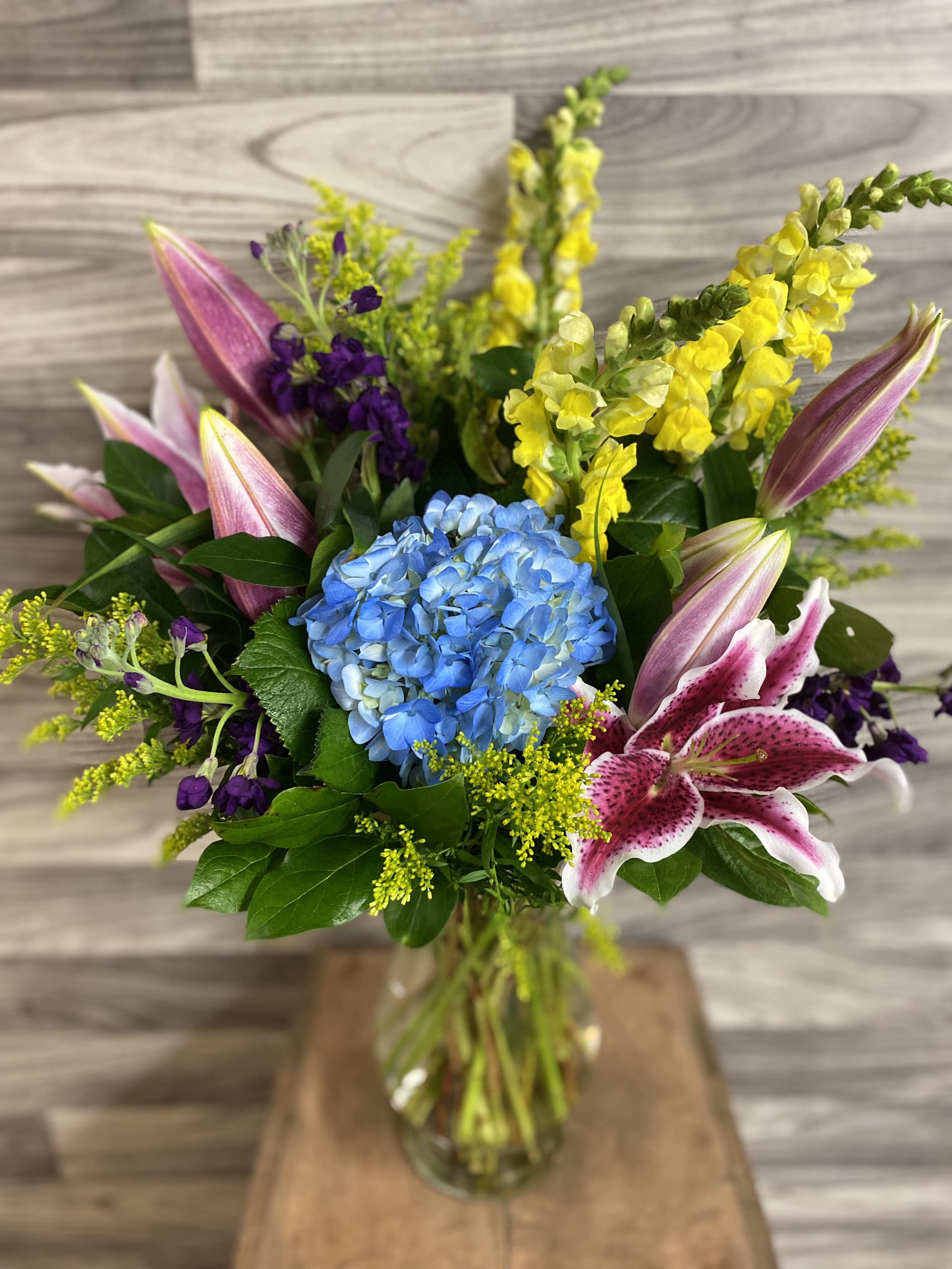 Love Everlasting Love Everlasting - Let the family at home know you are thinking of them with this lovely bouquet of pink lilies, blue hydrangea and other floral favorites. It will mean a lot.