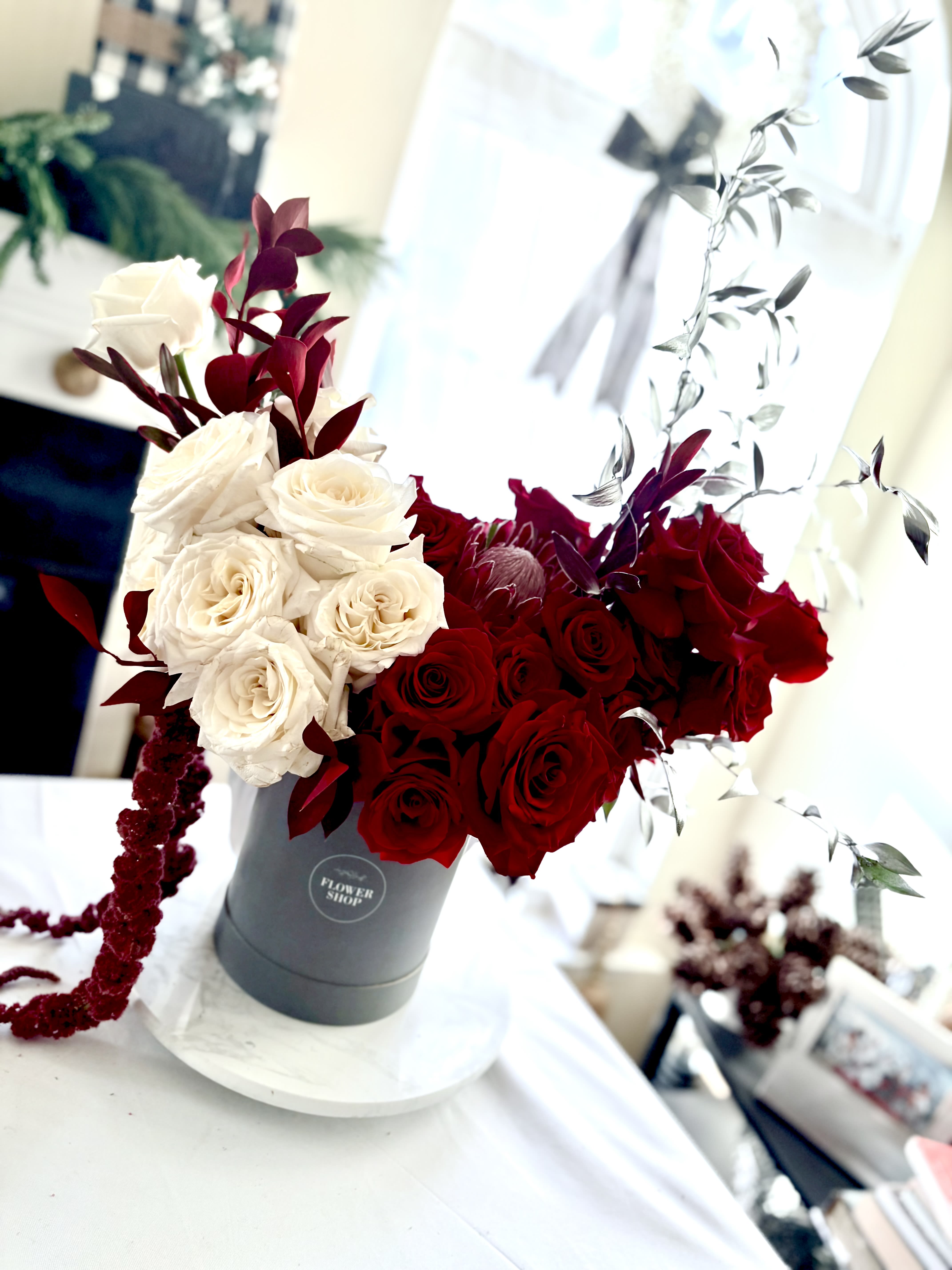 Luxury Bloom Box - Let them know you love and appreciate them by showering them in luxury with this gorgeous arrangement.  This two tone luxurious arrangement is crafted in a high end French, influenced, vintage style hat box.  The shape of the design is exquisite and sure to impress.  Make a statement with this show stopper.