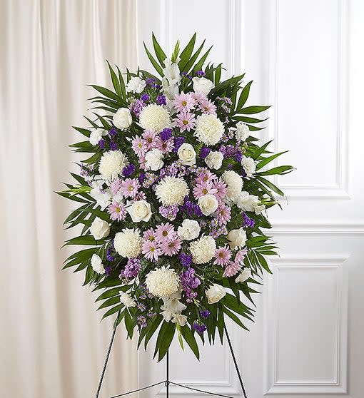 LAVENDER & WHITE SYMPATHY STANDING SPRAY - 148719A LAVENDER & WHITE SYMPATHY STANDING SPRAY - 148719A - When words alone cannot convey the feelings in your heart, flowers can provide a grand statement. Our impressive standing spray arrangement is meticulously handcrafted by expert local florists with soothing lavender and white blooms for a lush, full presentation, creating an elegant and memorable tribute. Standing spray arrangement with lavender daisy poms, stock and monte casino; white roses, Oriental lilies, football mums, gladiola and carnations; purple statice; accented with soft, lush greenery
