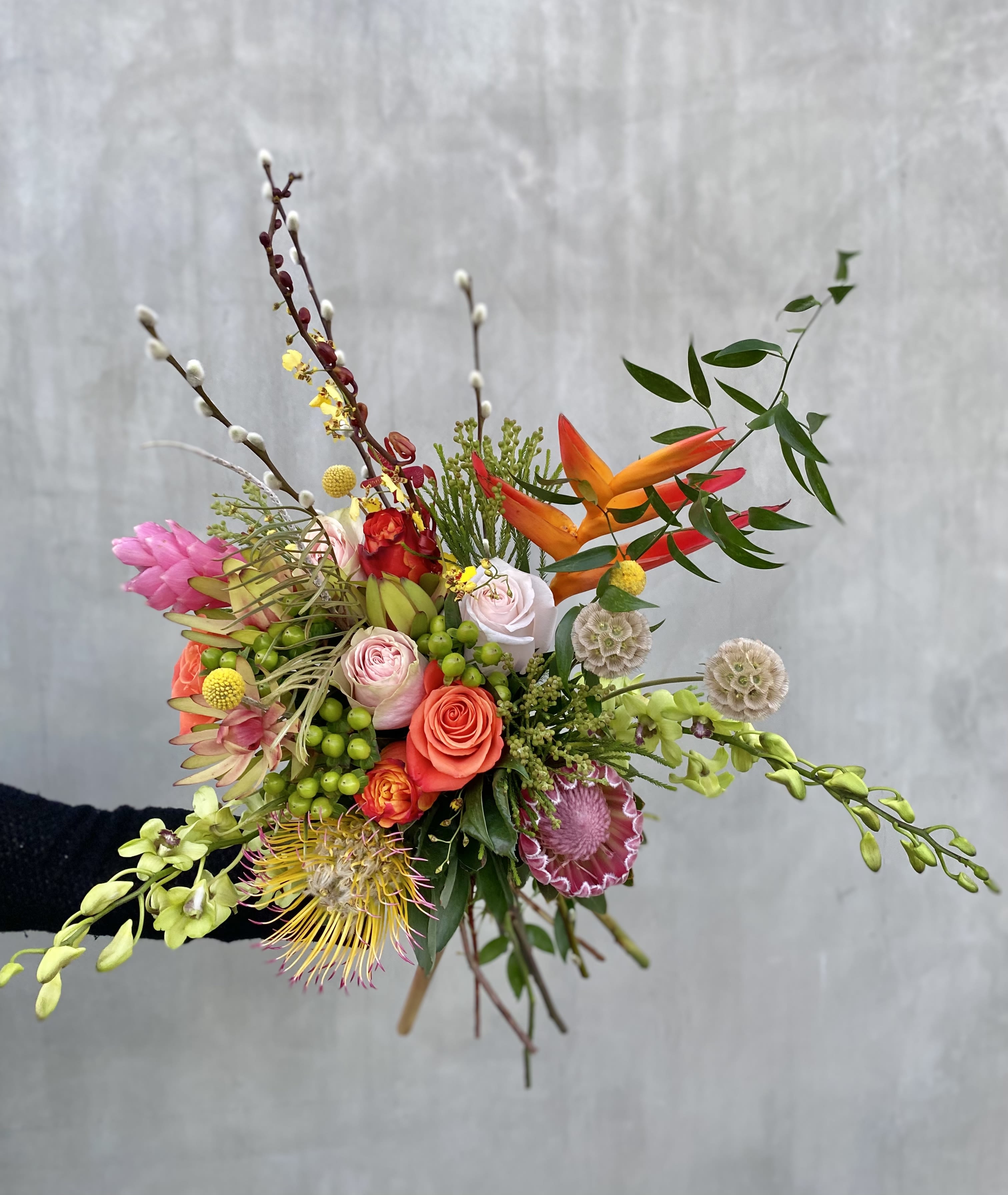 Get Wild Bouquet  -  This wild bouquet includes a variety of seasonal blooms wrapped in brown paper.