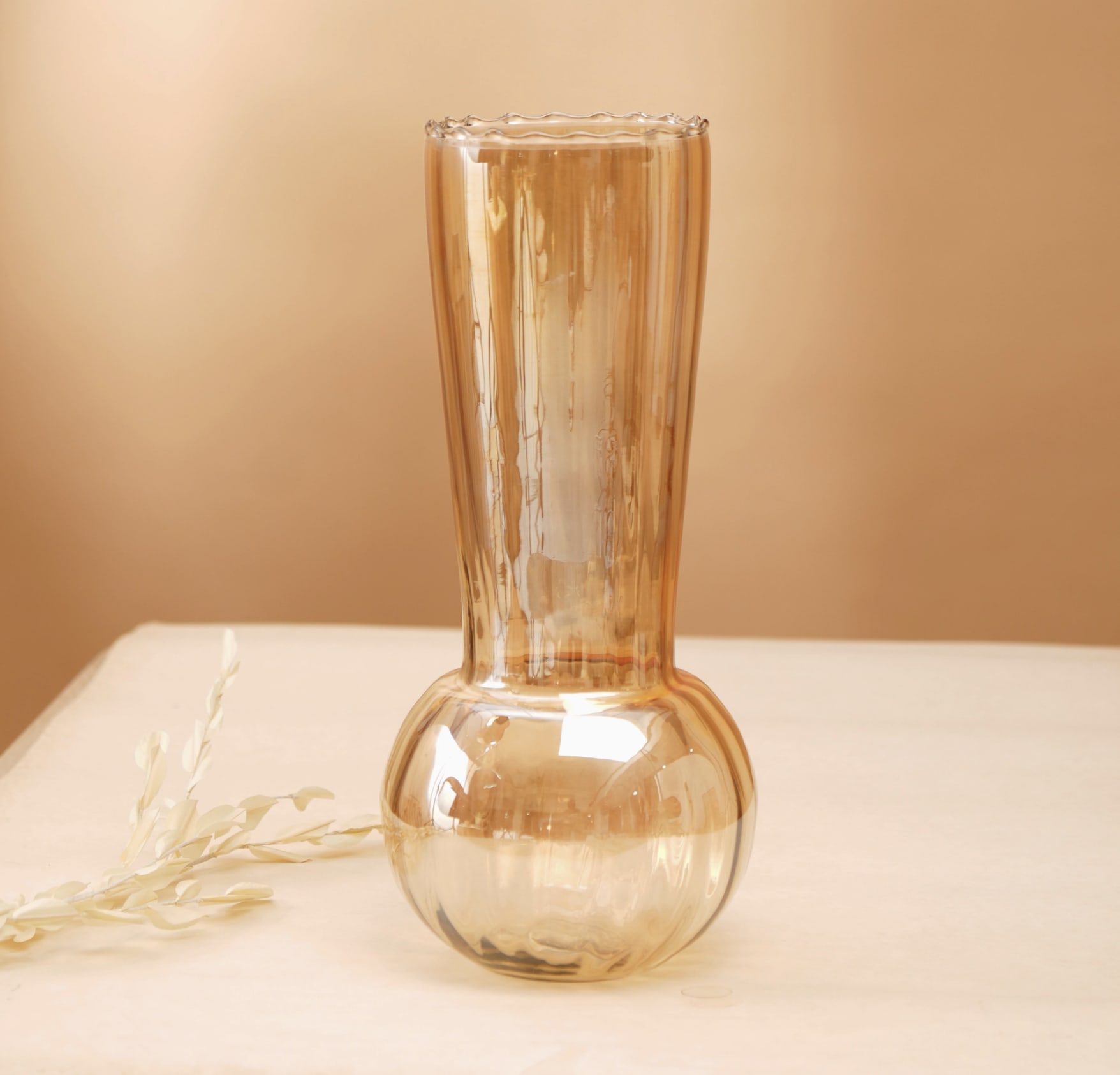 Whimsy Whirlpool Vase - The Whimsy Whirlpool Vase is a stunning handcrafted glass piece that brings vibrant color, unique texture, and artistry to your home. Created using the mouth-blown glass technique, each vase is one-of-a-kind, featuring a lustrous, iridescent finish that shimmers with metallic tones and reflects light in a captivating way.  Its swirling, whimsical design adds both movement and elegance, making it a perfect statement piece for any room. Whether filled with fresh flowers, dried stems, or displayed on its own, the Whimsy Whirlpool Vase effortlessly enhances any decor with its beautiful, reflective quality.   Dimensions: 5.5 x 5.5 x 10 in (14 x 14 x 25.4 cm)  Ethically sourced &amp; handmade in India  Exclusively available at Chartreuse by Roje  A fusion of artistry, texture &amp; iridescent beauty  A true reflection of fine craftsmanship, the Whimsy Whirlpool Vase brings a touch of whimsy and elegance to your space, transforming it into a haven of light and color.