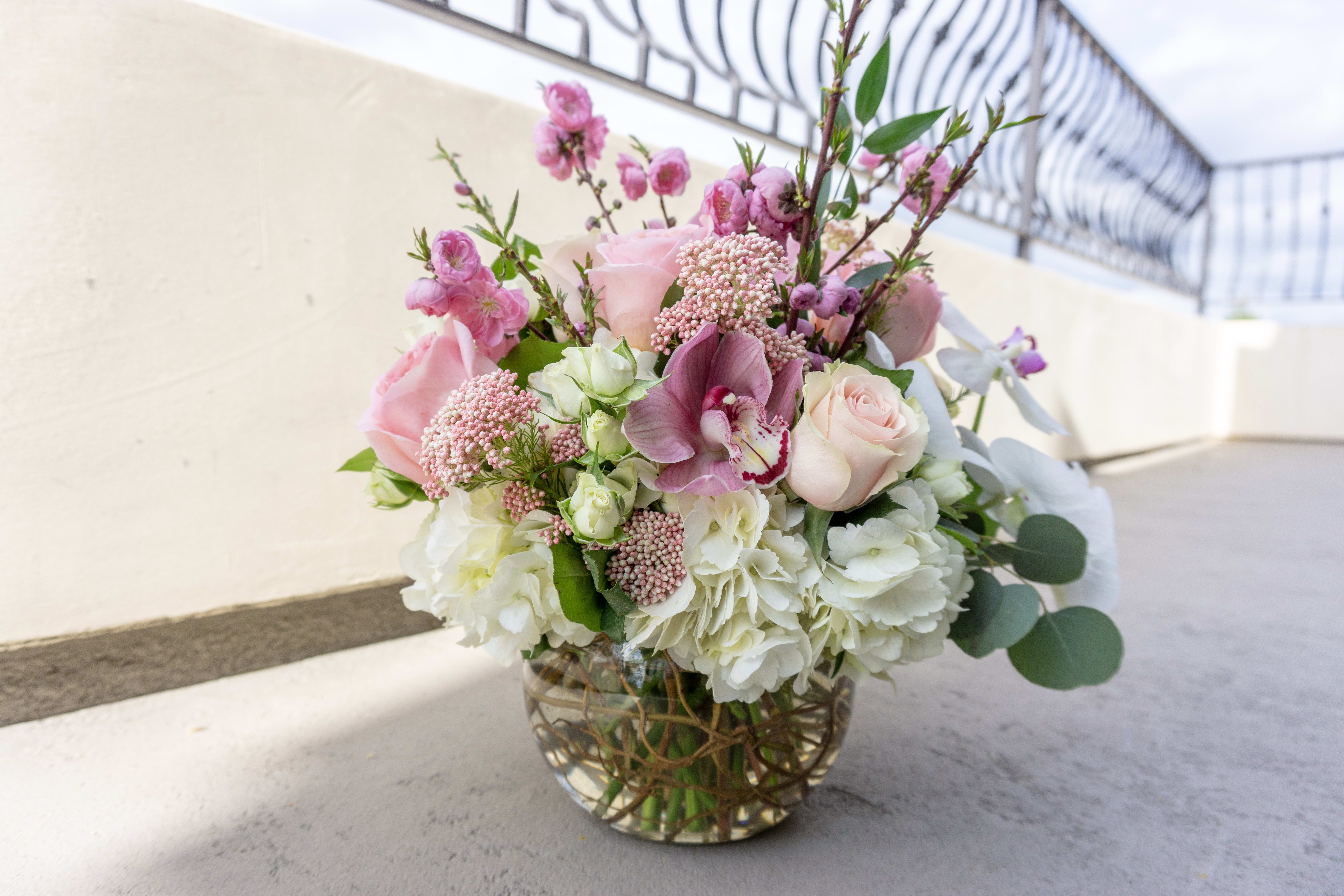 Touch of Rosa Touch of Rosa - Mixture of roses, orchids, hydrangeas, greenery, spray roses, and more.
