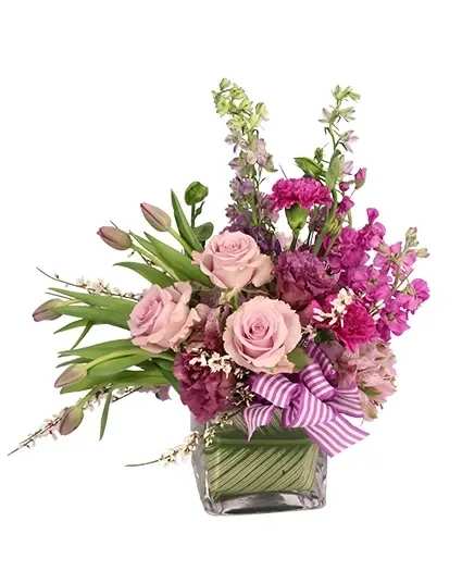 PURE RADIANCE FLOWER ARRANGEMENT PURE RADIANCE FLOWER ARRANGEMENT - What a dream! The varying shades of purples and lavenders create a wondrous mix full of lovely carnations, tulips, roses, and more. Pure Radiance is sure to be a hit with anyone who sees it. Send this striking lavender bouquet to someone you love today!
