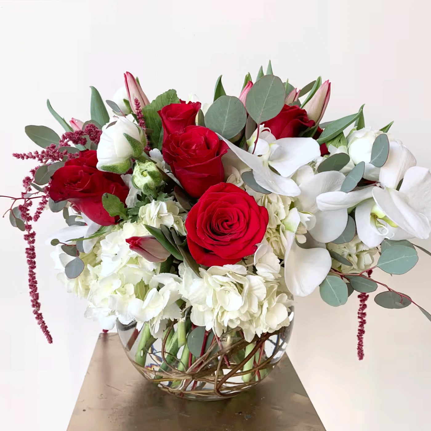 TOUCH OF LOVE TOUCH OF LOVE - TOUCH OF LOVE - RED ROSES, HYDRANGEAS, WHITE ORCHIDS, SILVER DOLLAR EUK, RANUNCULUS, TULIPS, AMANTHRUS, OTHER SEASONAL GREENERY AND FLORALS