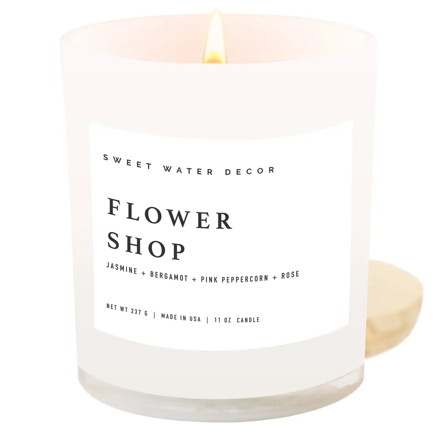 Sweetwater Decor 11 oz Soy Candle - Flower Shop Sweetwater Decor 11 oz Soy Candle - Flower Shop - SCENT NOTES: • Top: Bergamot Rind, Orange Blossom, Lemon • Middle: Middle: Ylang Ylang, Jasmine, Damask Rose • Base: Pink Peppercorn, Neroli, Rosewood • Burn Time: 50+ Hours • Wick: 100% Cotton (Lead and Zinc Free) • Wax: Proprietary Soy Based Wax Blend | Vegan, Non-GMO, Kosher • Premium Fragrance Oil • Gluten Free, Phthalate Free, Non-Toxic • Made in Pittsburgh, PA CANDLE CARE: • Always Trim Your Wick to 1/4" Before Candle is Lit • Burn Candle so Wax Pool Reaches the Jar Edge Each Time to Prevent Wax Tunneling • Burn Candle No More Than 4 Hours at a Time & Do Not Burn Candle with Less Than a 1/2" of Wax Remaining • Keep Candle Away from Fans, Open Windows, Hot Surfaces, Children, Pets • Never Leave a Burning Candle Unattended