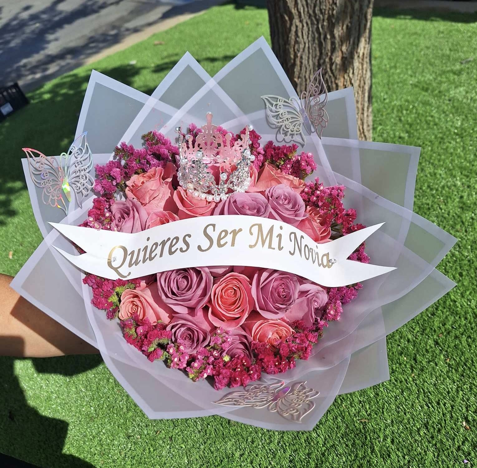 Be My Love - Ask her out with this lovely assorted bouquet. Which includes 2 dozen’s roses, a statice rim, in a wrapped style bouquet. Call us to make custom changes.