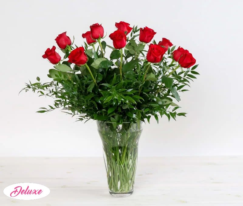 Dozen Long Stemmed Roses Dozen Long Stemmed Roses - This Beautiful vase of 12 roses is arranged in a clear glass vase. The complimenting greenery allows for a full and rich looking arrangement. You can choose ONE color - RED, PINK, WHITE, YELLOW, PEACH or LAVENDER (put your color chose in the special instructions box)