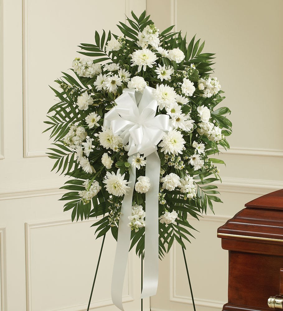 Deepest Sympathy Spray Deepest Sympathy Spray - A traditional all white standing spray with carnations, daisies, mums, and a white bow.