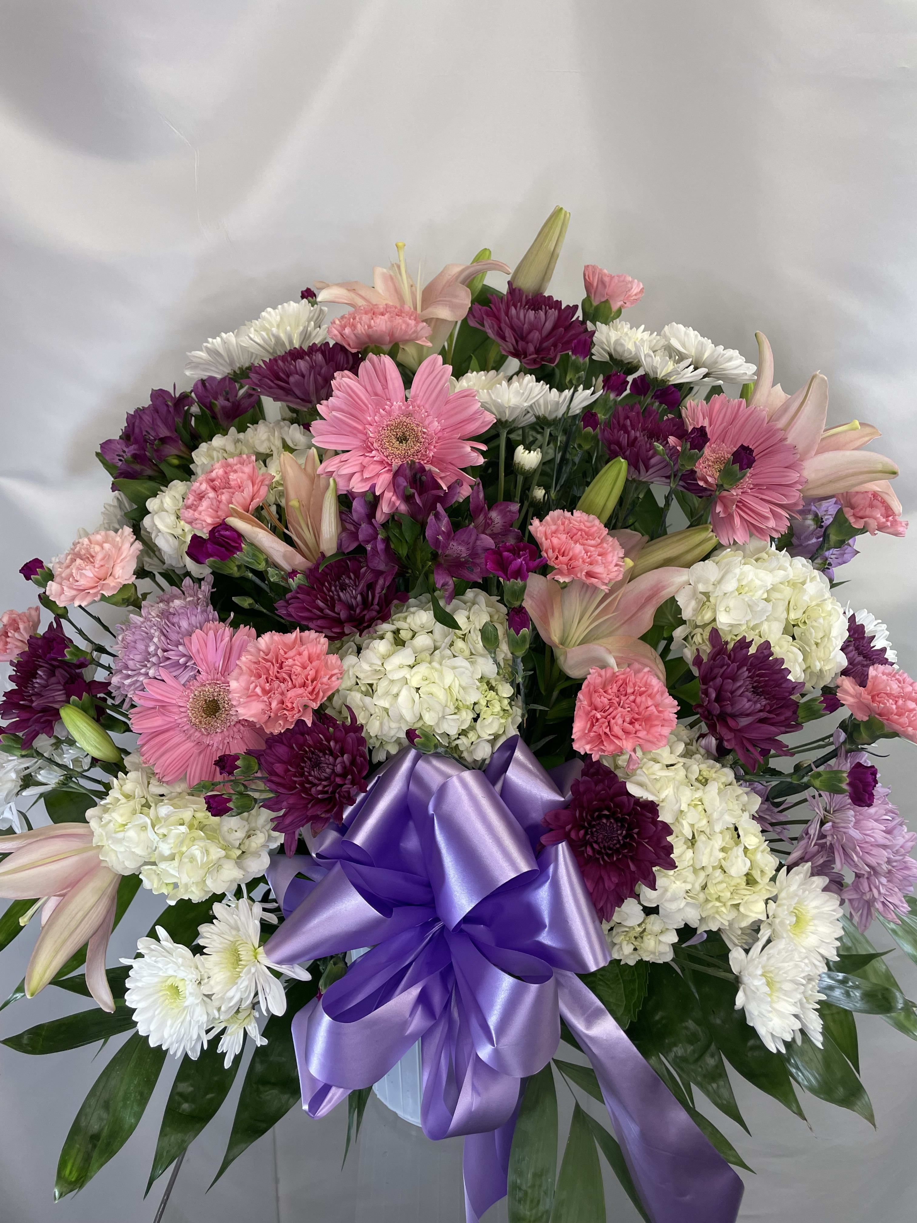 Everlasting Light Basket  - A lovely assortment of pink, white and purple flowers. This basket is full of Roses, Carnations, Gerber Daisys, Hydrangea and other choice flowers.  