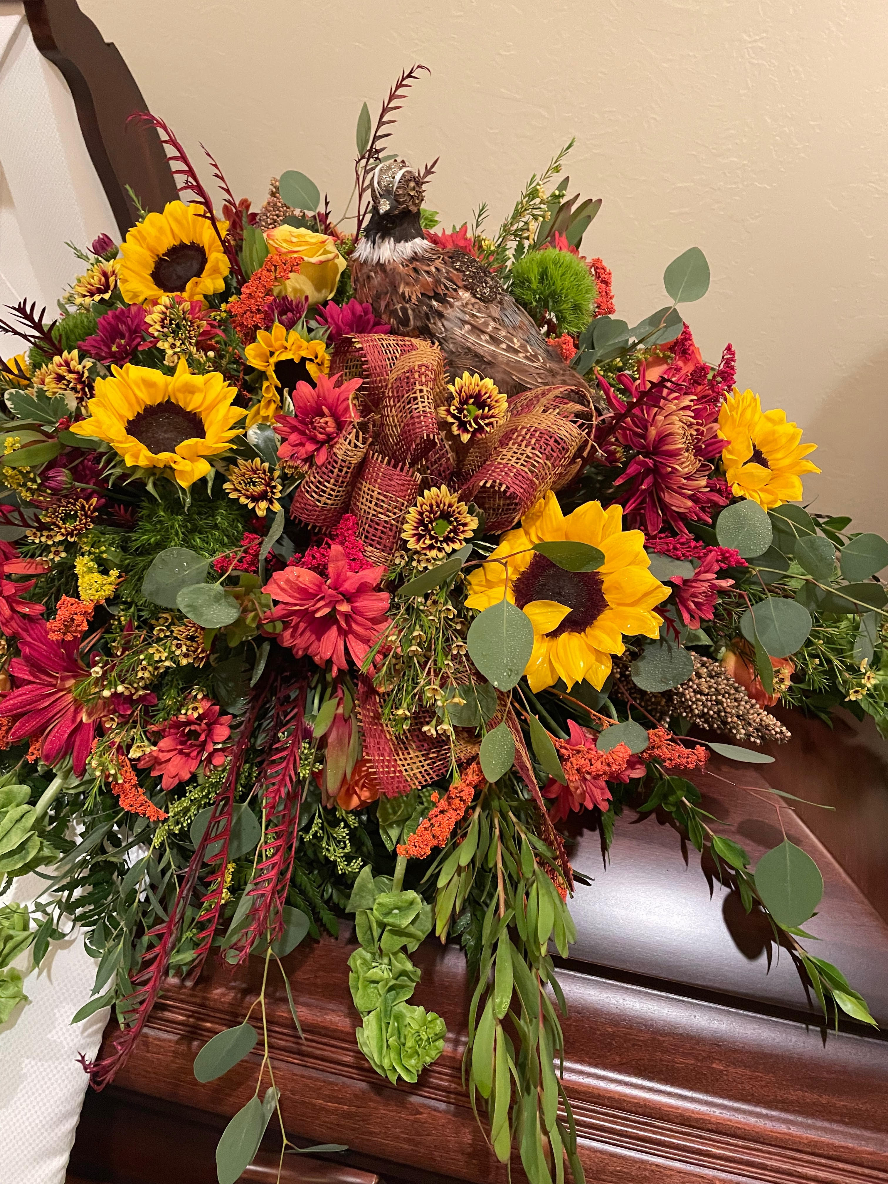 wildlife casket piece - casket piece fill with sunflower fall daisy orange roses lots of different greens topped with a pheasant .