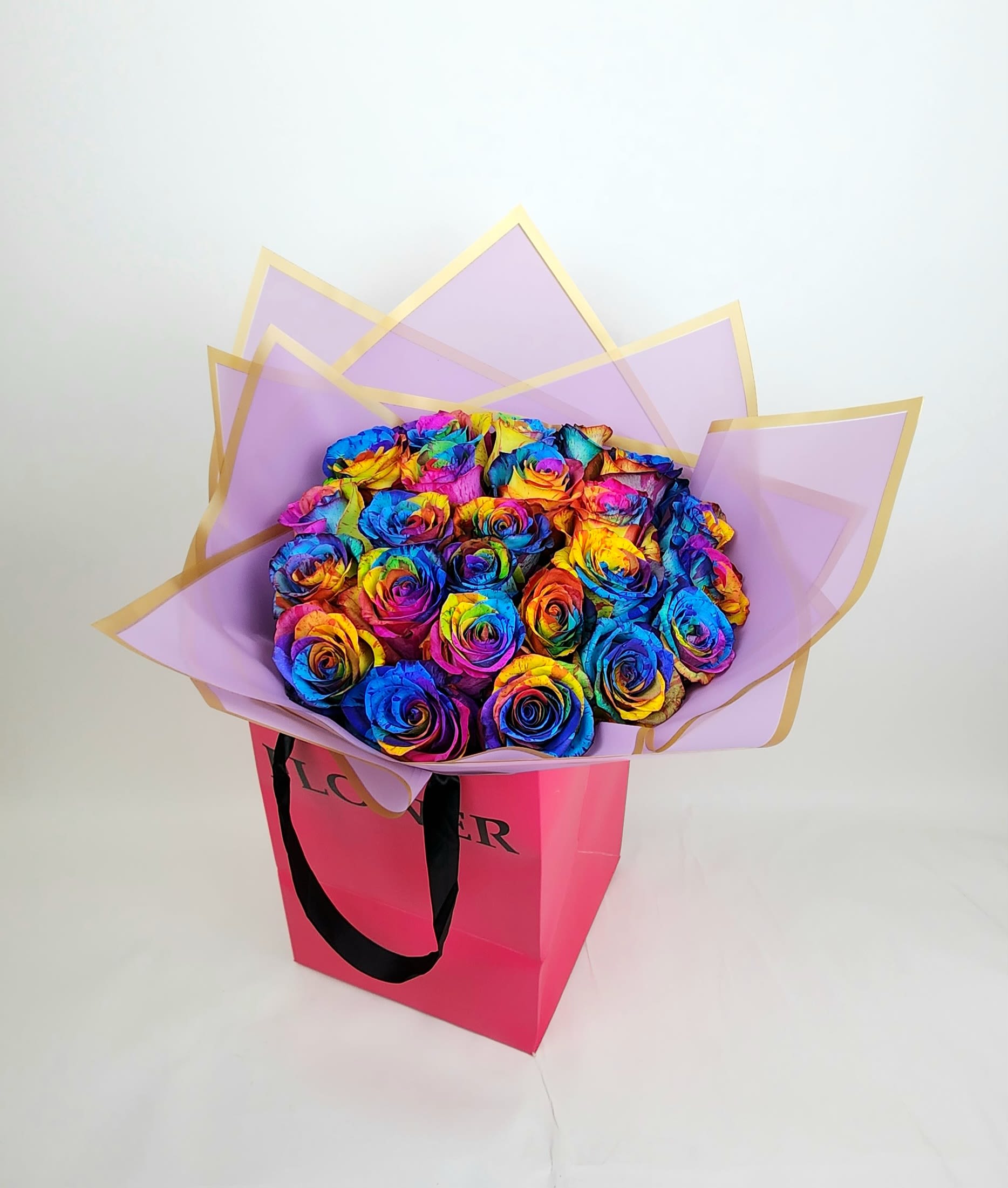 Proudly in love - A rainbow-tainted roses in a bouquet wrapping in plastic papers. ( 12,18, and 24 Roses ) and with a paper bag to hold them.  (this product needs to be pre order 24 hours before} *The picture is the Premium version 24 roses 