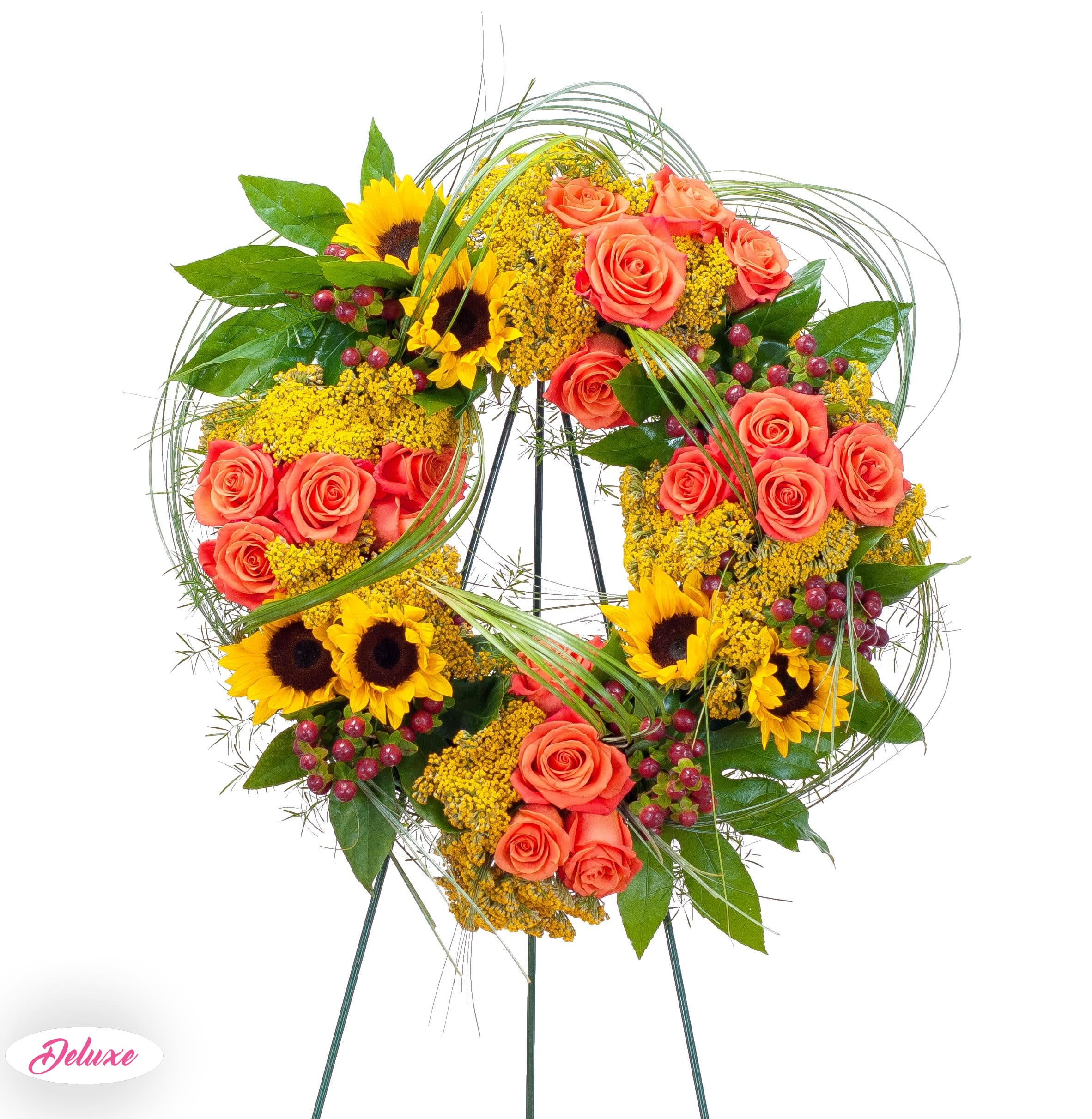  Heaven's Sunset Wreath -  The colors of sunset are evident in this beautiful wreath including sunflowers and roses with accents of other premium flowers and foliage. 